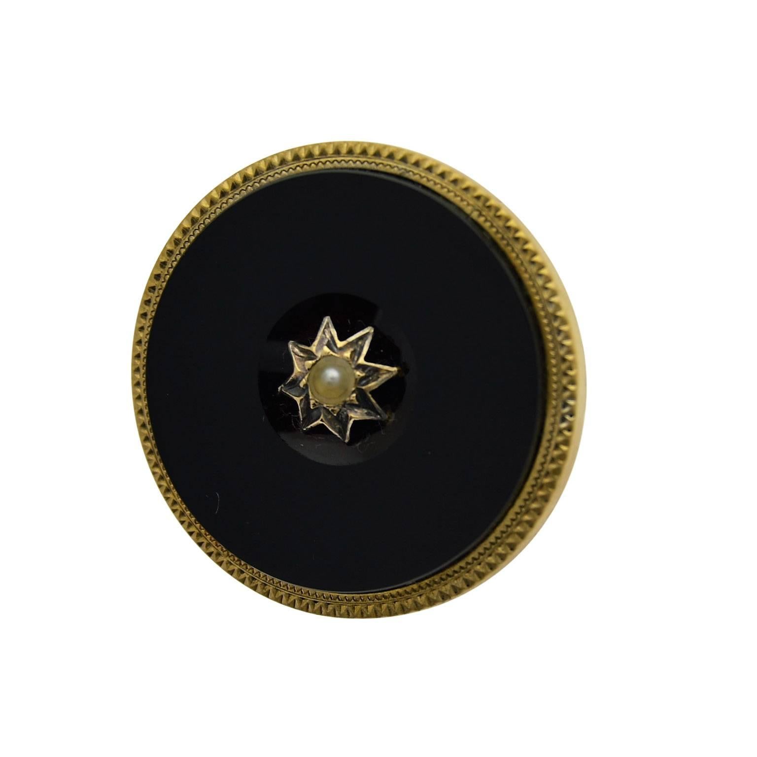 This 30mm diameter onyx pin has a gold eight pointed star in the center and natural pearl inset.
The piece is in excellent condition and entirely hand constructed.
There are no chips or scratches on the face of the stone.
It is sophisticated and