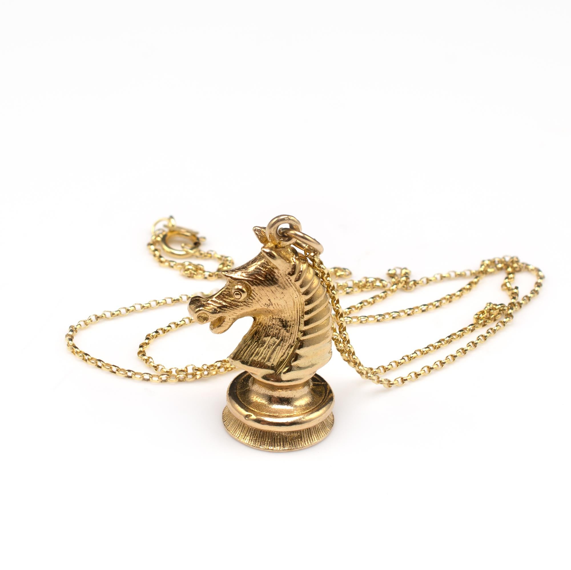 This gold Knight chess piece pendant displays full hallmarks for London 1971.

The gold horse, displays engraved detail to the front and a stylized mane with graduated overlapping bands of gold. Holding ring attached with bale ring and complimentary