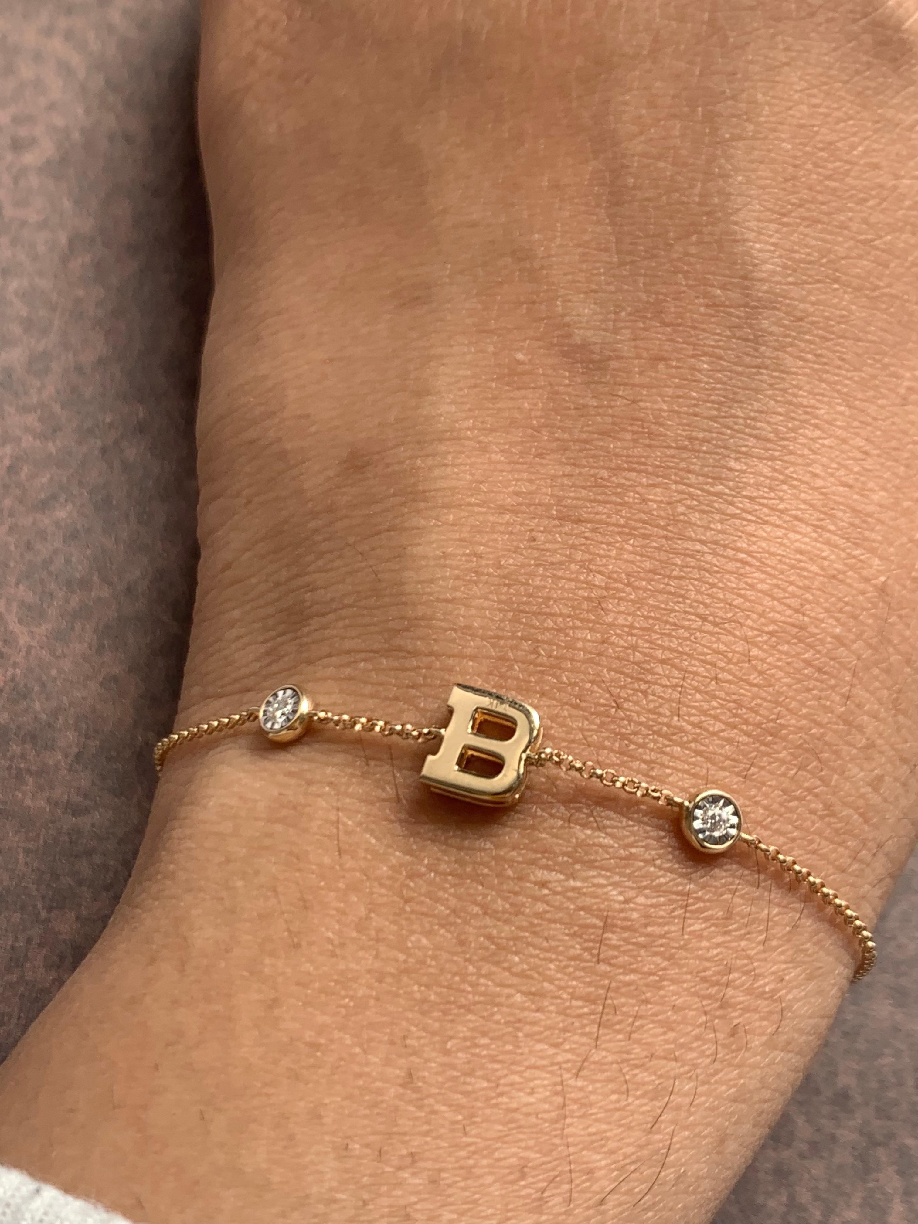 Solid gold initial bracelets with diamonds! Made in 14k yellow gold, with 2 diamonds, 1 on each side, this bracelet is as beautiful as you! The letters are made with 14k plain gold and the diamonds are set in a miracle disc! You get the look of a