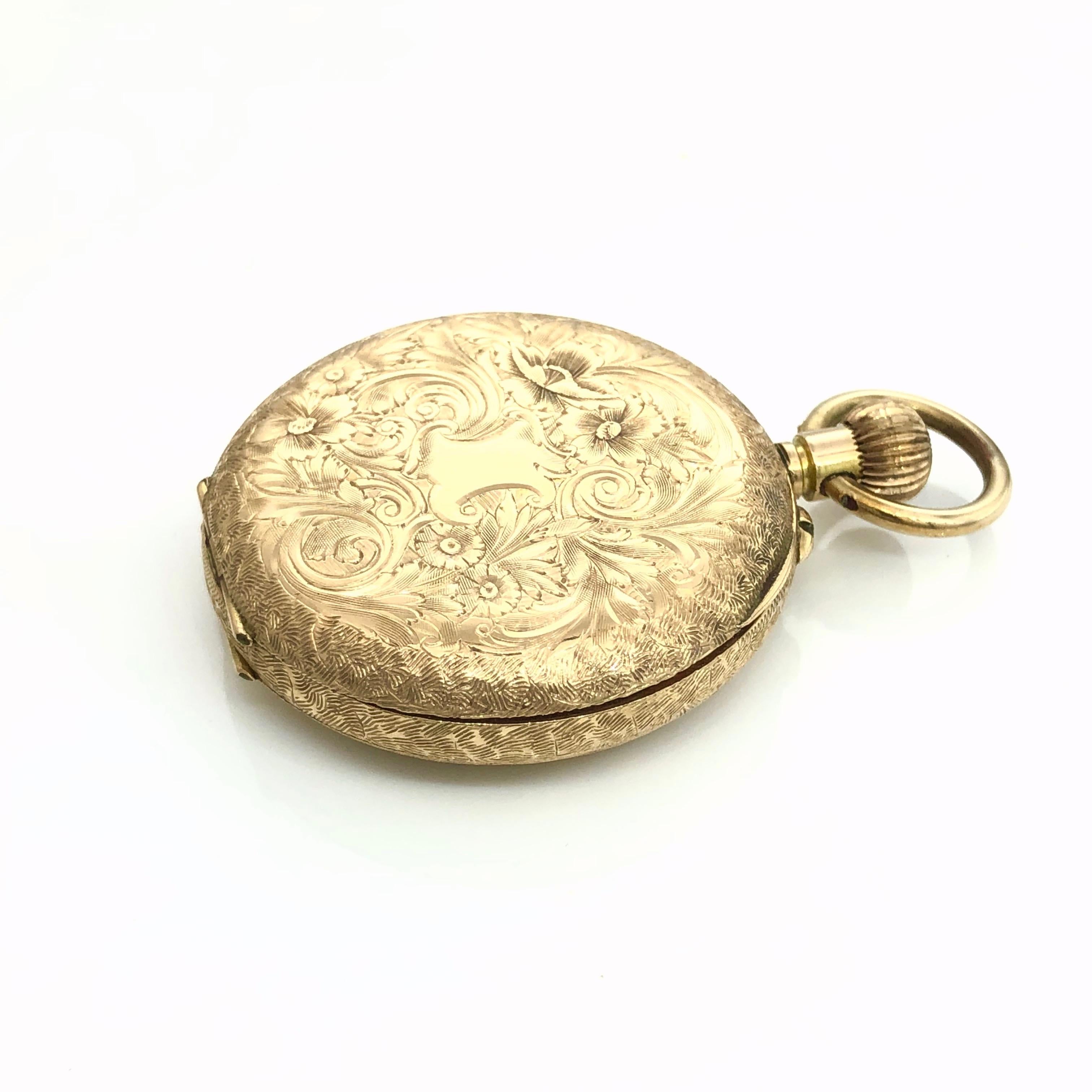 Elegant Stewart Dawson & Co 14 carat Solid Gold Open Face Ladies Pocket Watch .
Late 19th - early 20th century, marked 14C to inner back cover and serial number #75128.
Featuring a gilt floral incised golden dial with Roman numerals,
engraved wide