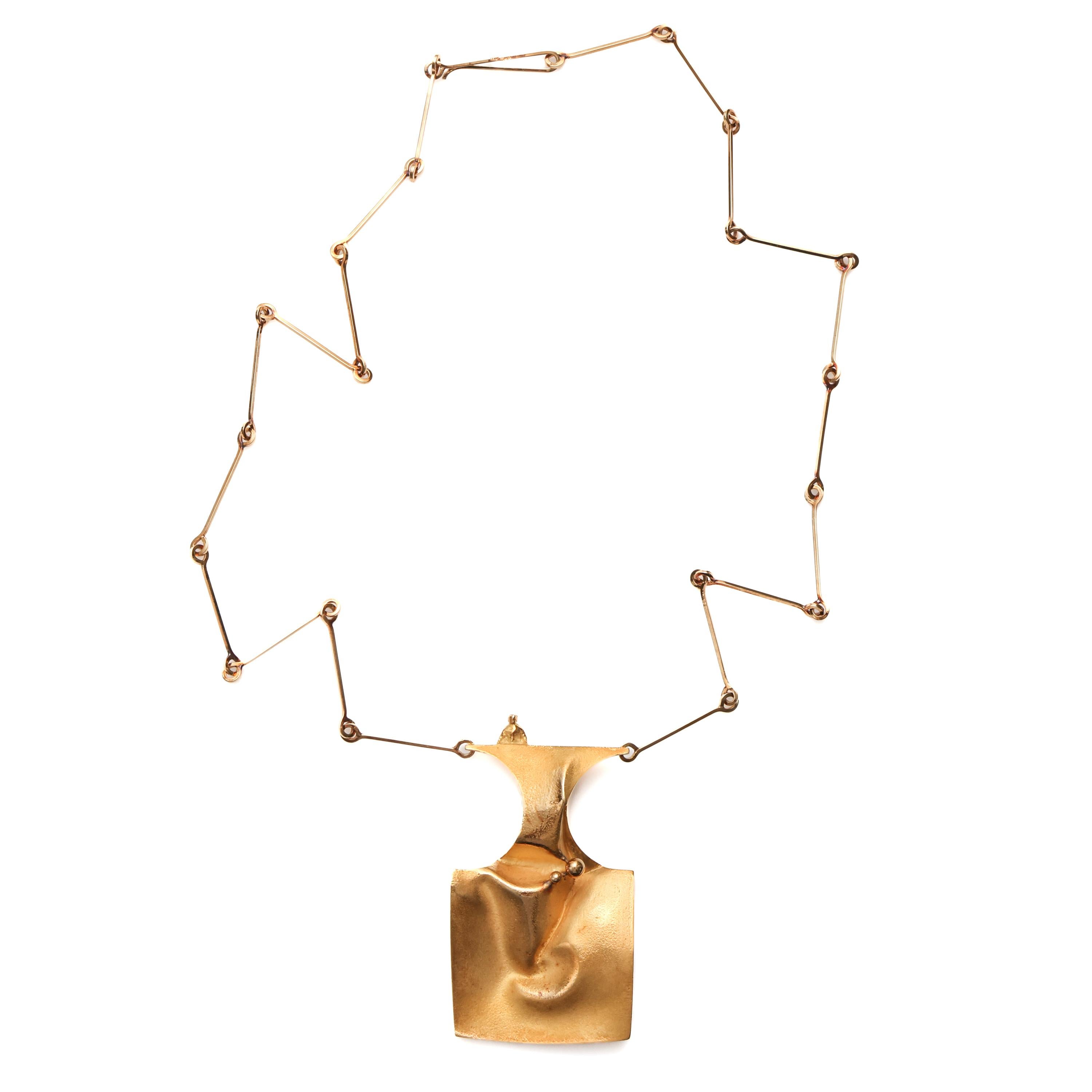 This luxurious solid (and very heavy) 18K yellow gold modernist necklace was created in the 1960s entirely by hand in South America by an unknown maker. Though the clasp is marked for metal fineness and there is a maker's mark, we are unable to