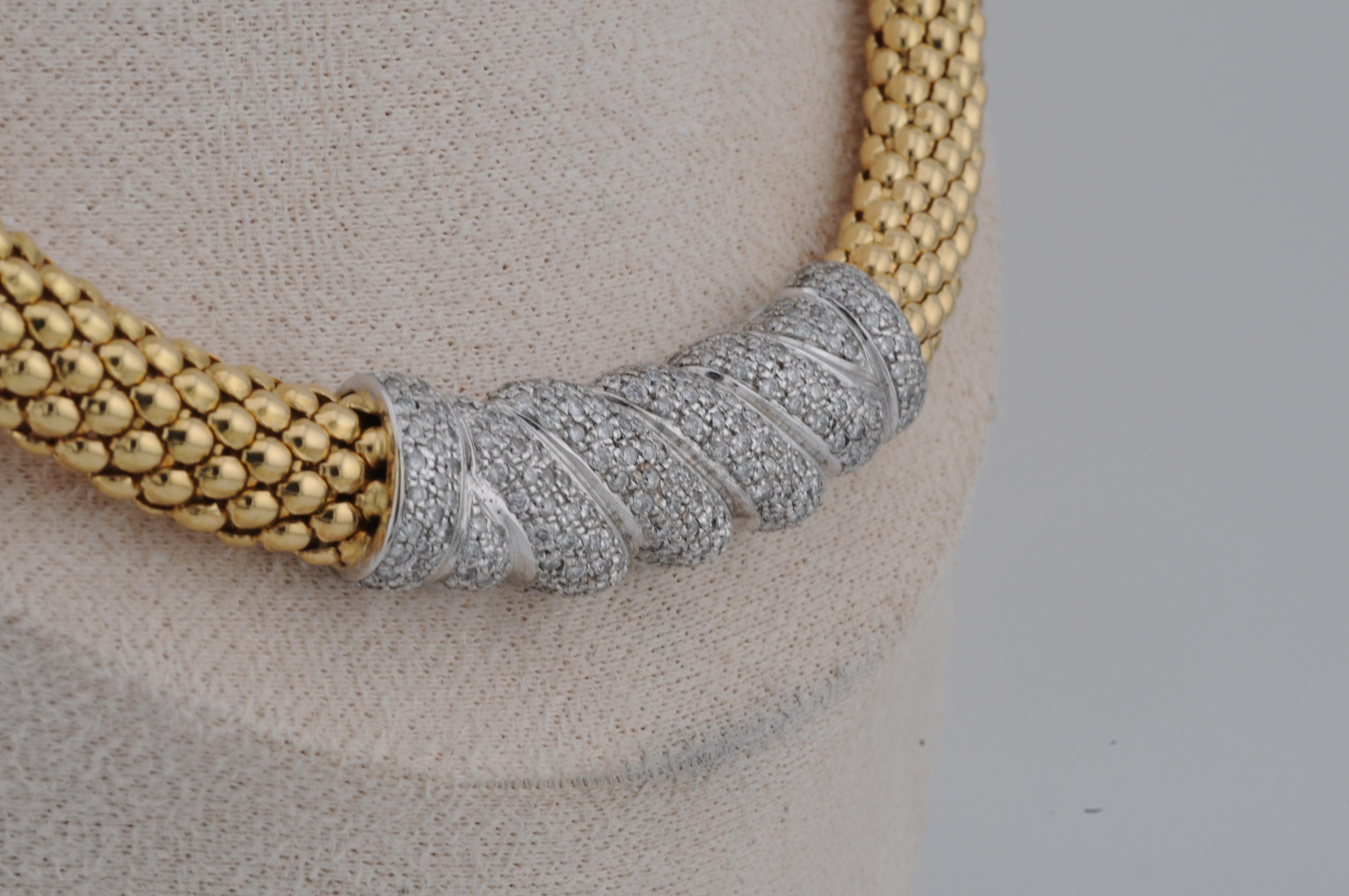 Exclusive necklace in 750 (18k) yellow gold, with a total weight of approximately 69g. Set with finely placed natural diamonds totaling around 2.12ct. The diamonds are elegantly integrated into the design, adding refined brilliance to this