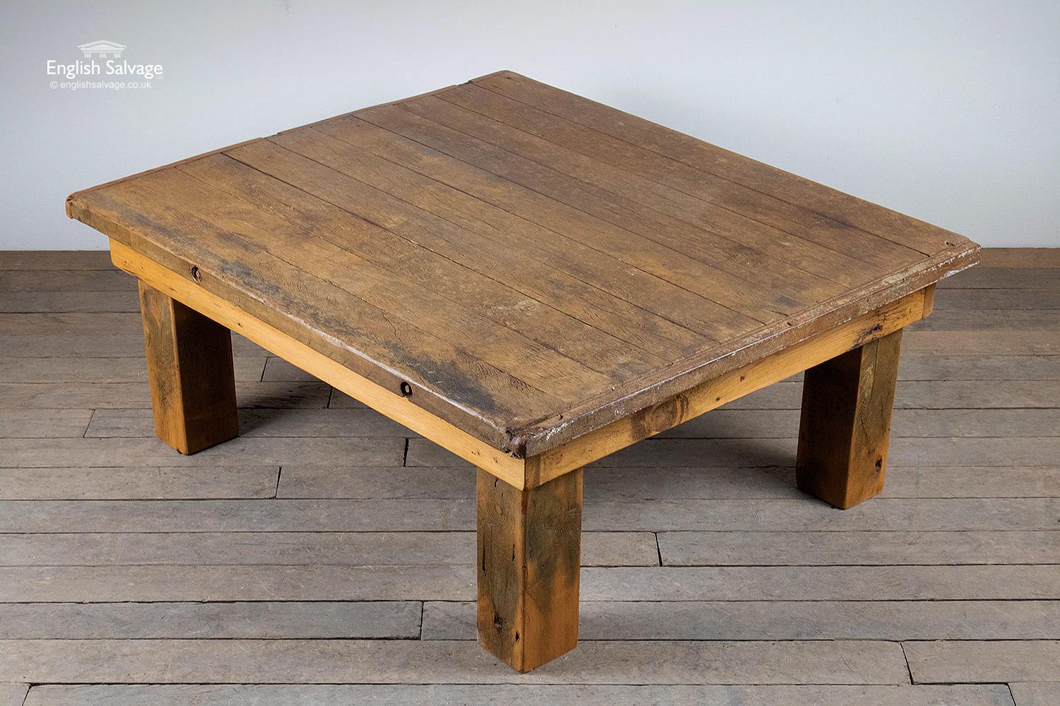 Chunky and substantial solid wood coffee table. Made from reclaimed wood, the top being a salvaged hardwood pottery board with iron bands to the edges. Quite rustic in appearance this heavy table has a lightly oiled / waxed finish which enhances the