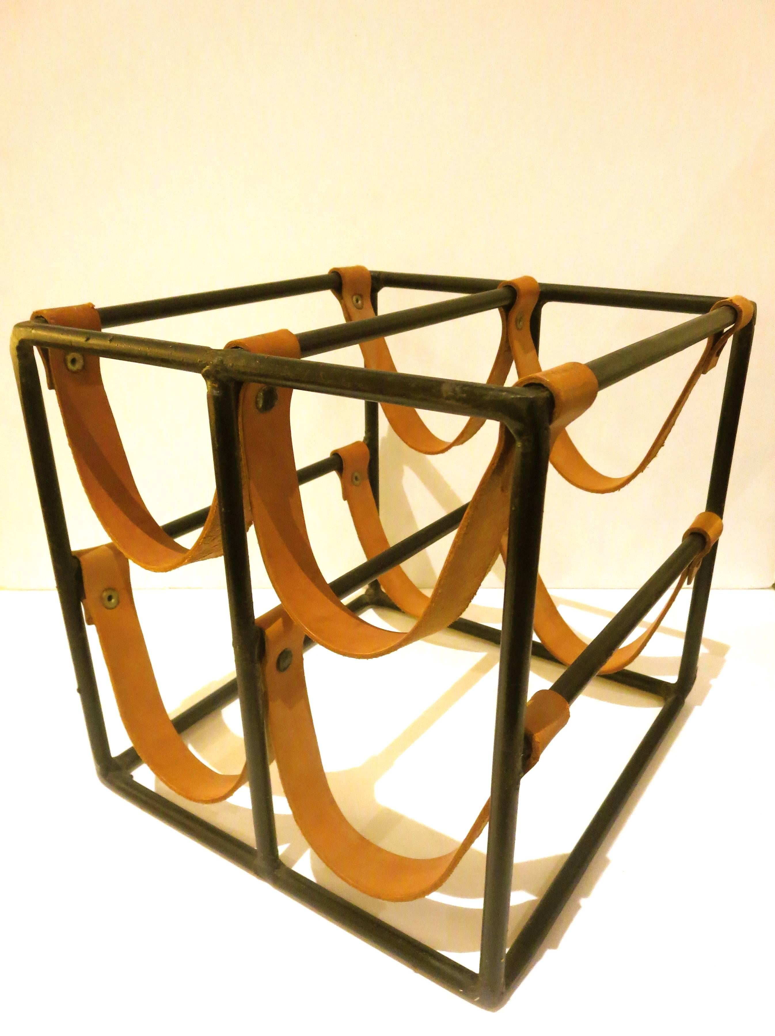 Simple and elegant design in this 1950s wine rack four bottle capacity, designed by Arthur Umanoff, leather straps holds each bottle nice design clean.