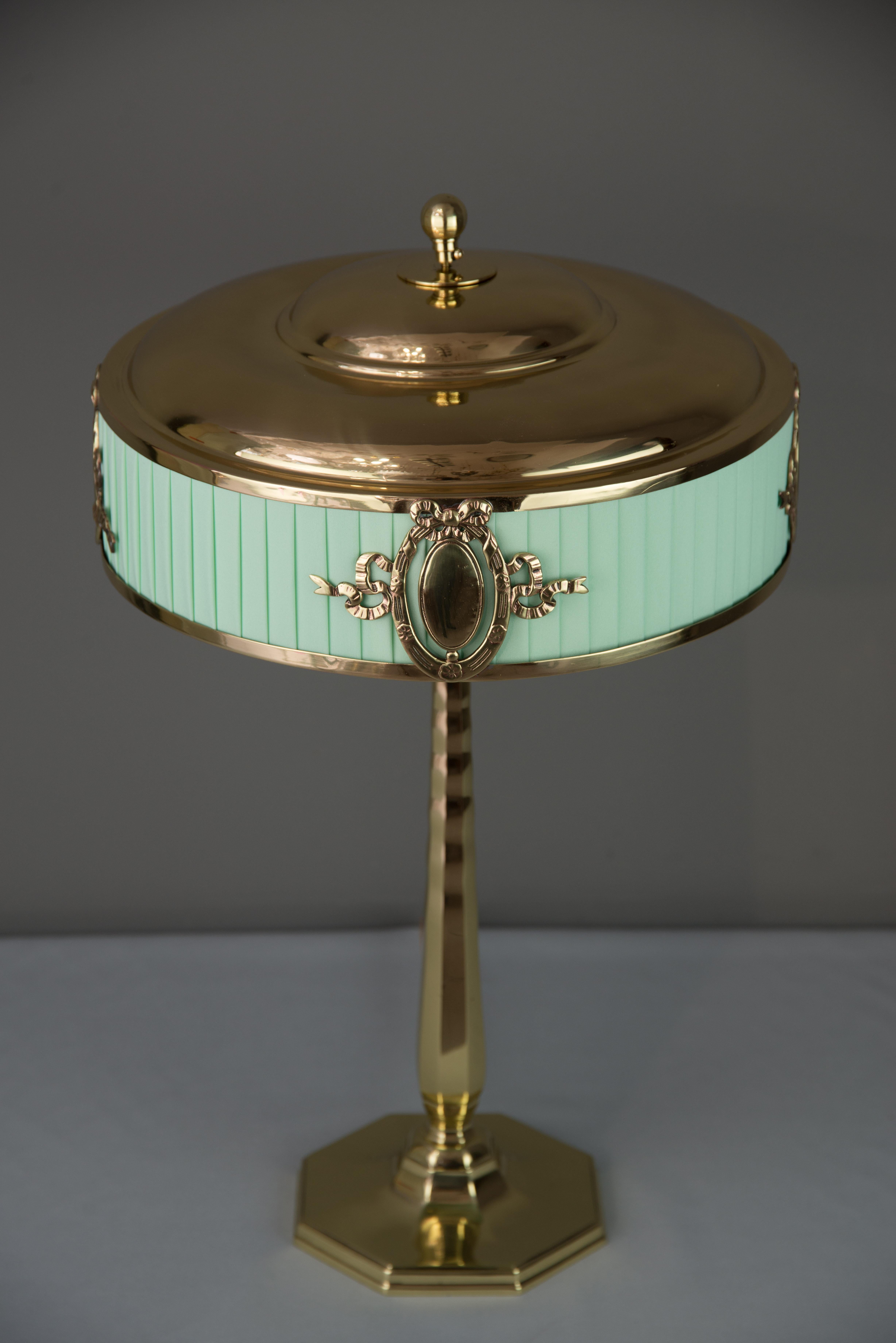 Solid Jugendstil table lamp, circa 1908
Polished and stove enameled
The green fabric is replaced (new).