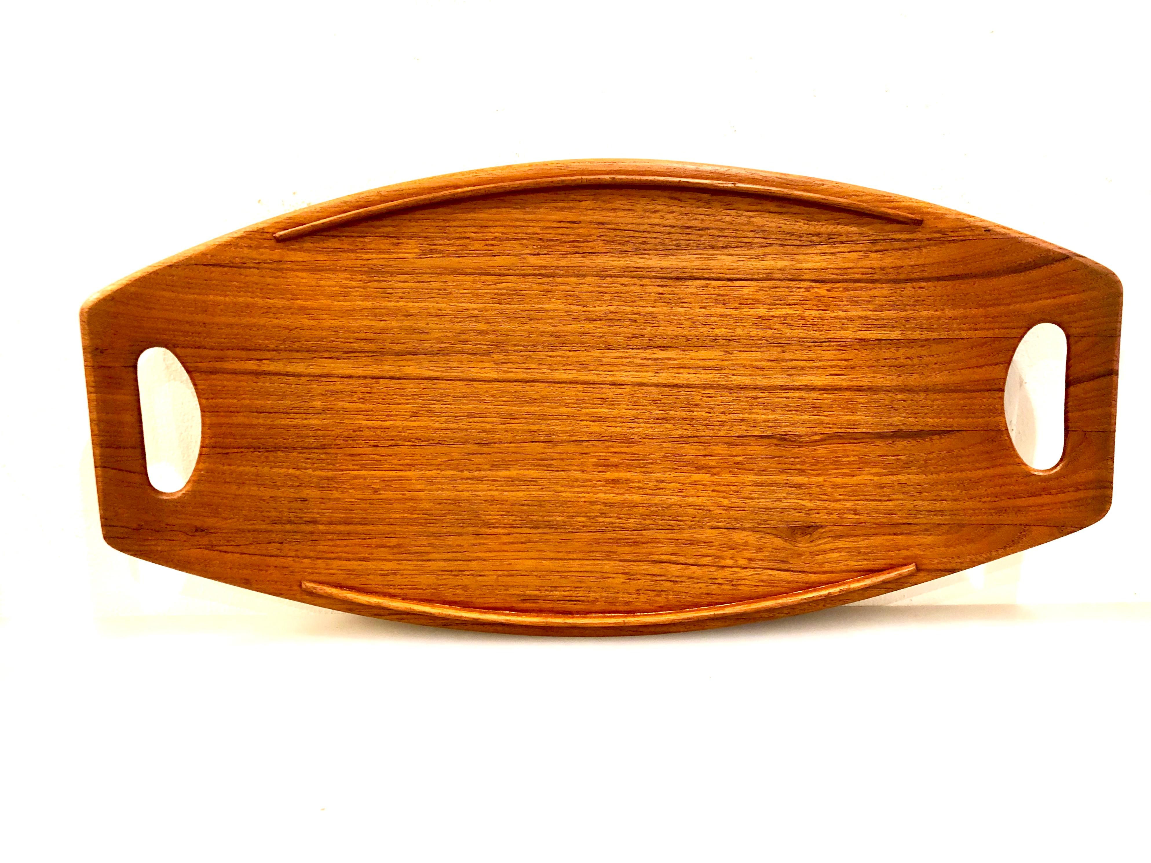 Beautiful solid teak gondola tray designed by Jens Quistgaard for Dansk; early production. Nice condition with raised edges and elegant lines. The large tray is 20 1/2