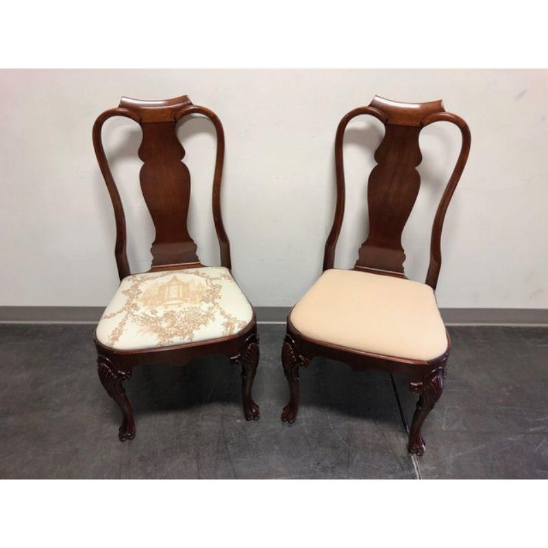 A pair of high-end dining chairs in the Queen Anne style, unbranded. Solid mahogany, carved knees, fluted feet. Made in the USA, likely 1980s. 

Measures: Overall: 22 W 23 D 42 H, Seats: 21.5 W 22 19 H

Exceptionally good condition with signs of