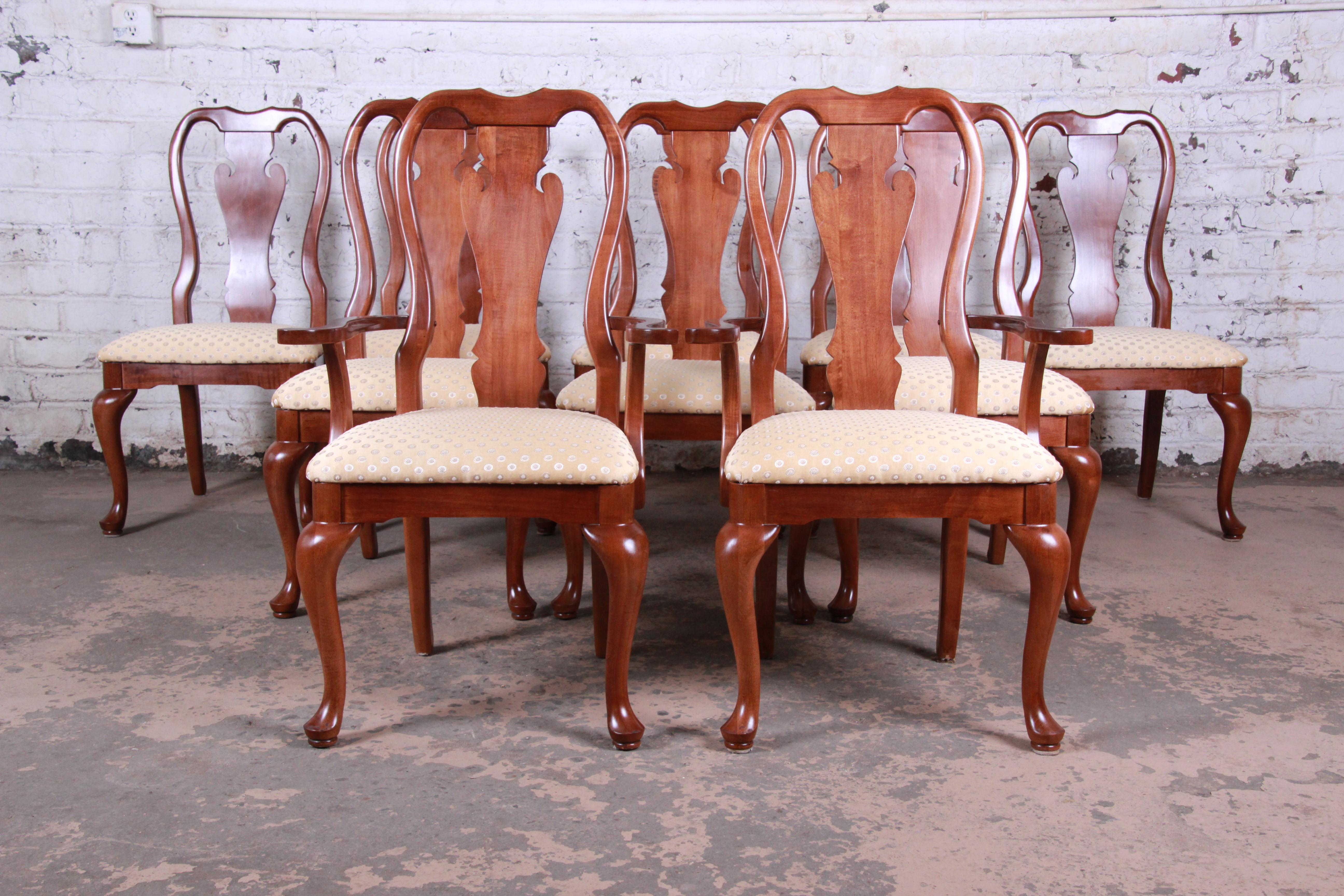 An outstanding set of ten mahogany Queen Anne style dining chairs. The set includes two armchairs and eight side chairs. The chairs feature solid mahogany frames and original gold upholstery in excellent condition. They were procured with the