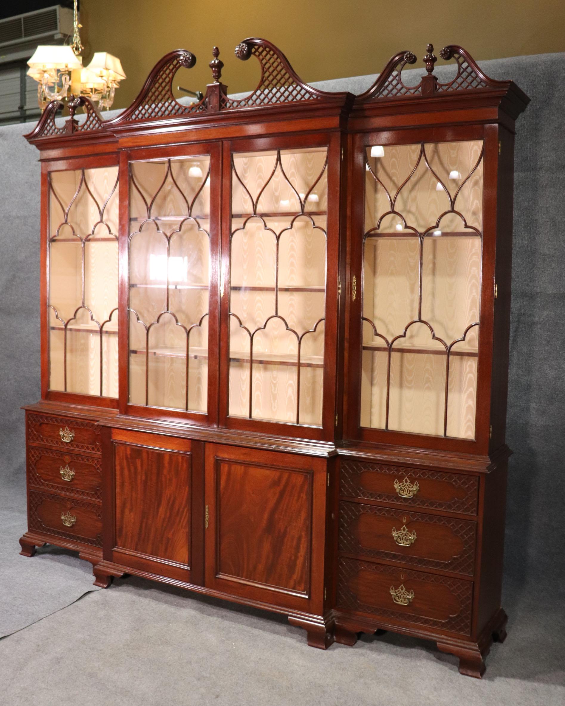 This incredible breakfront is solid mahogany and custom made so it can be broken down into much smaller sections allowing for easy moving and assembly inside any home, no matter what encumbrances may stand it the way of normal larger sized pieces.