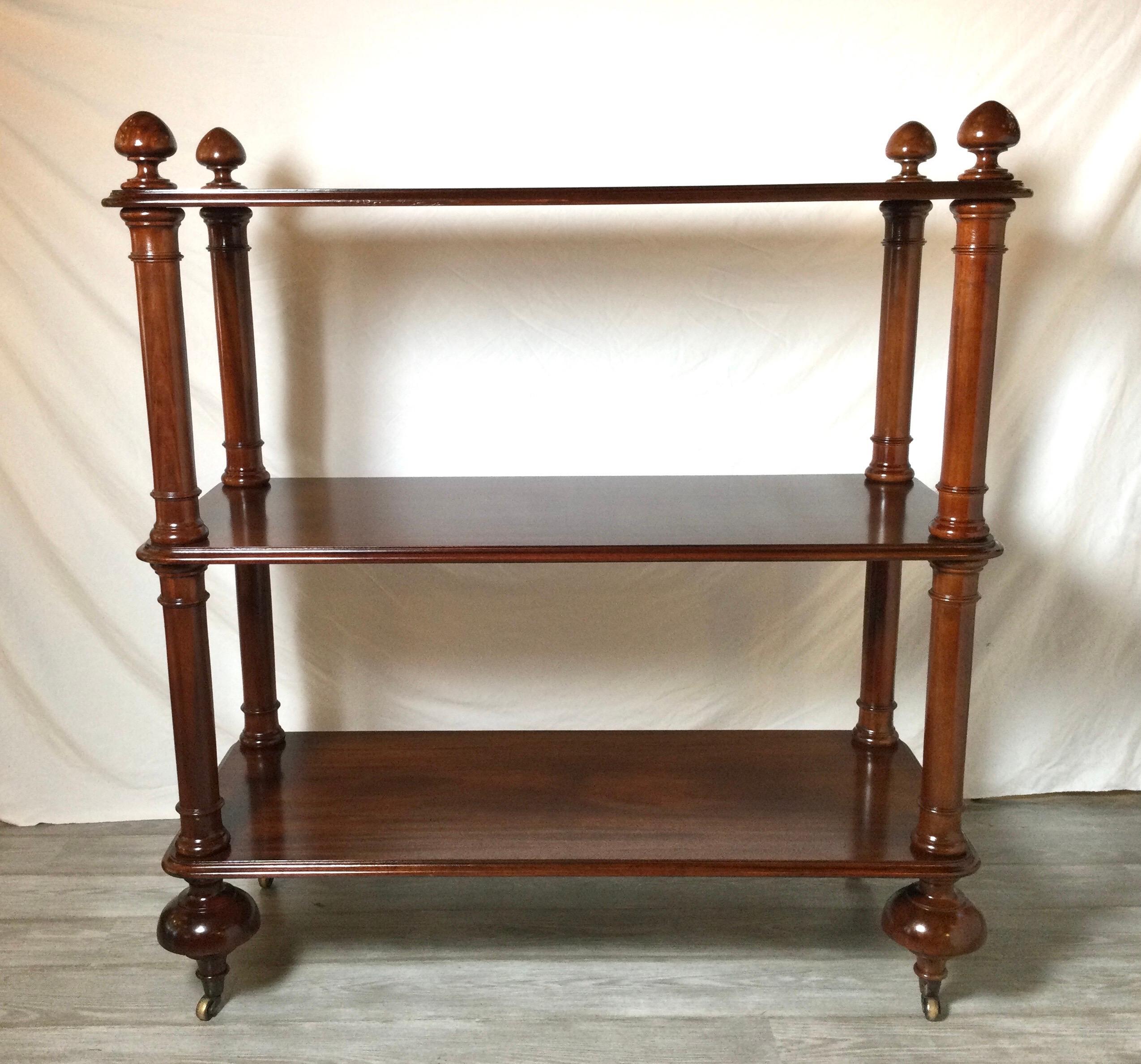Solid Mahogany three tiered silent butler/server. The solid wood shelves with turned posts at the corners with original solid brass castors. Classic William IV styling but made in the early part of the 20th century 
A beautiful piece of furniture