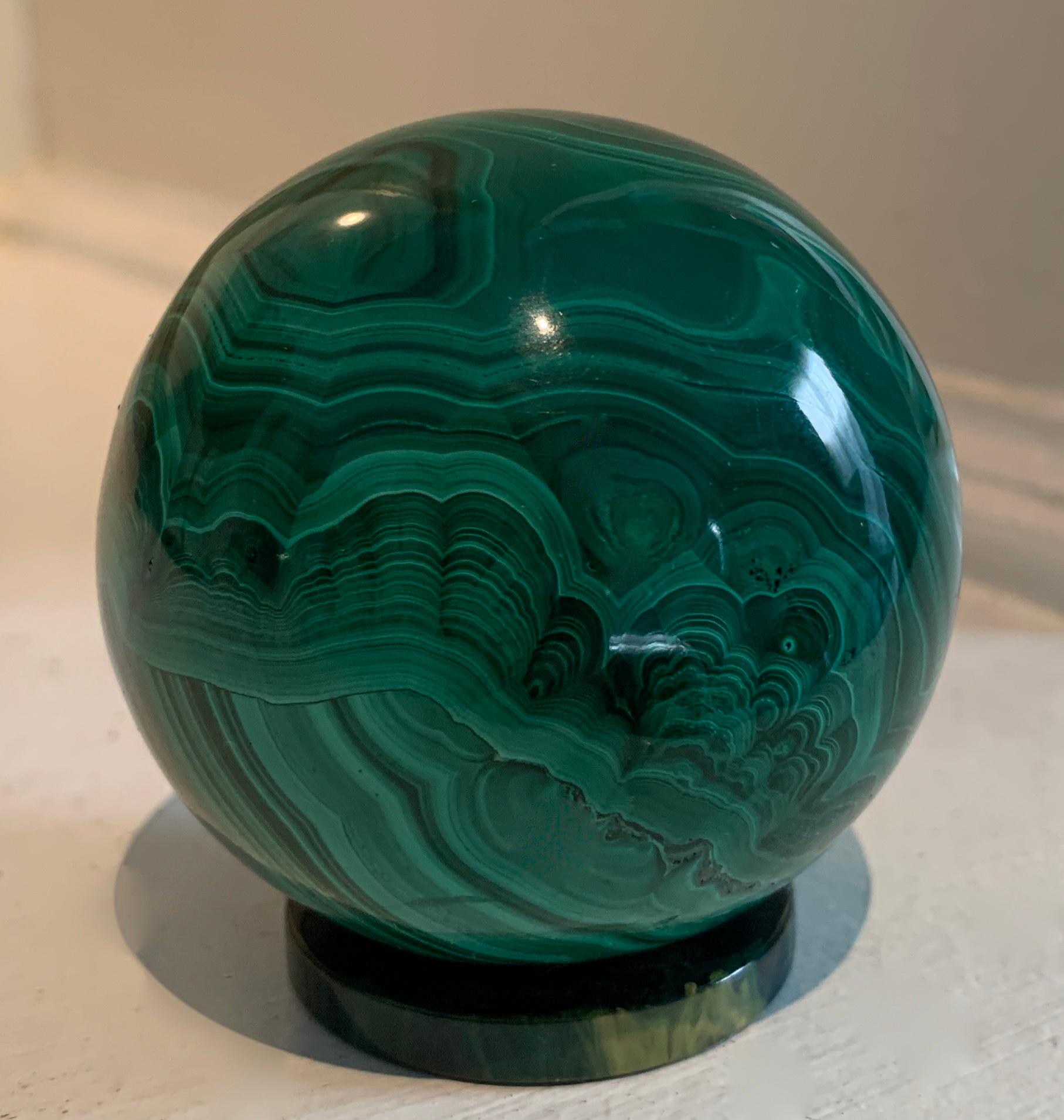 A malachite sphere / ball perfectly suited as an object d'arts for the desk as a stand alone or paper weight.  The piece is also wonderful for a collection of stones or malachite.  A very sexy piece - simple and architectural.  Russian malachite -