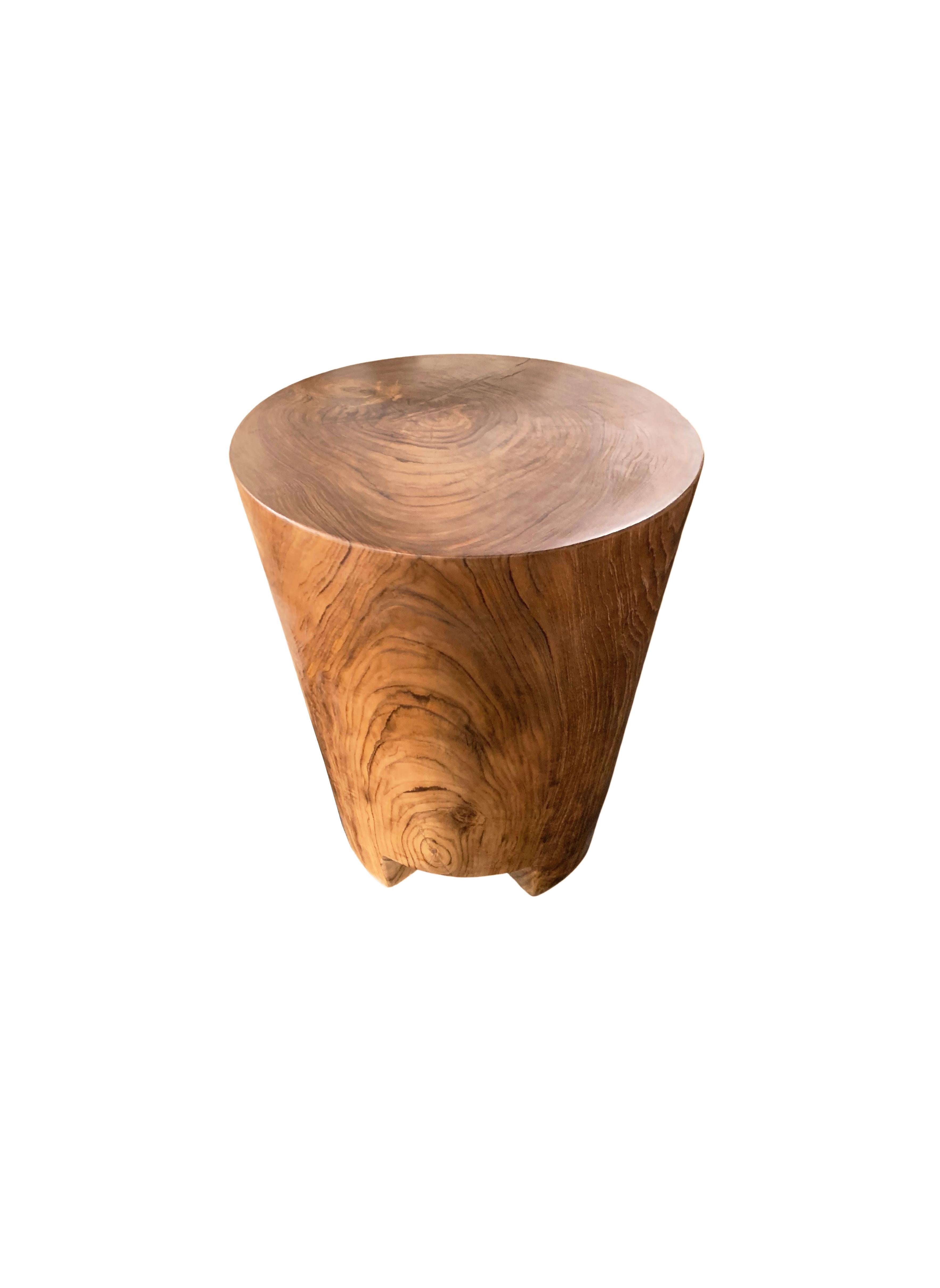 A wonderfully sculptural round side table. Its neutral pigments make it perfect for any space. A uniquely sculptural and versatile piece certain to invoke conversation. It was crafted from a solid block of mango wood and has a smooth texture finish.