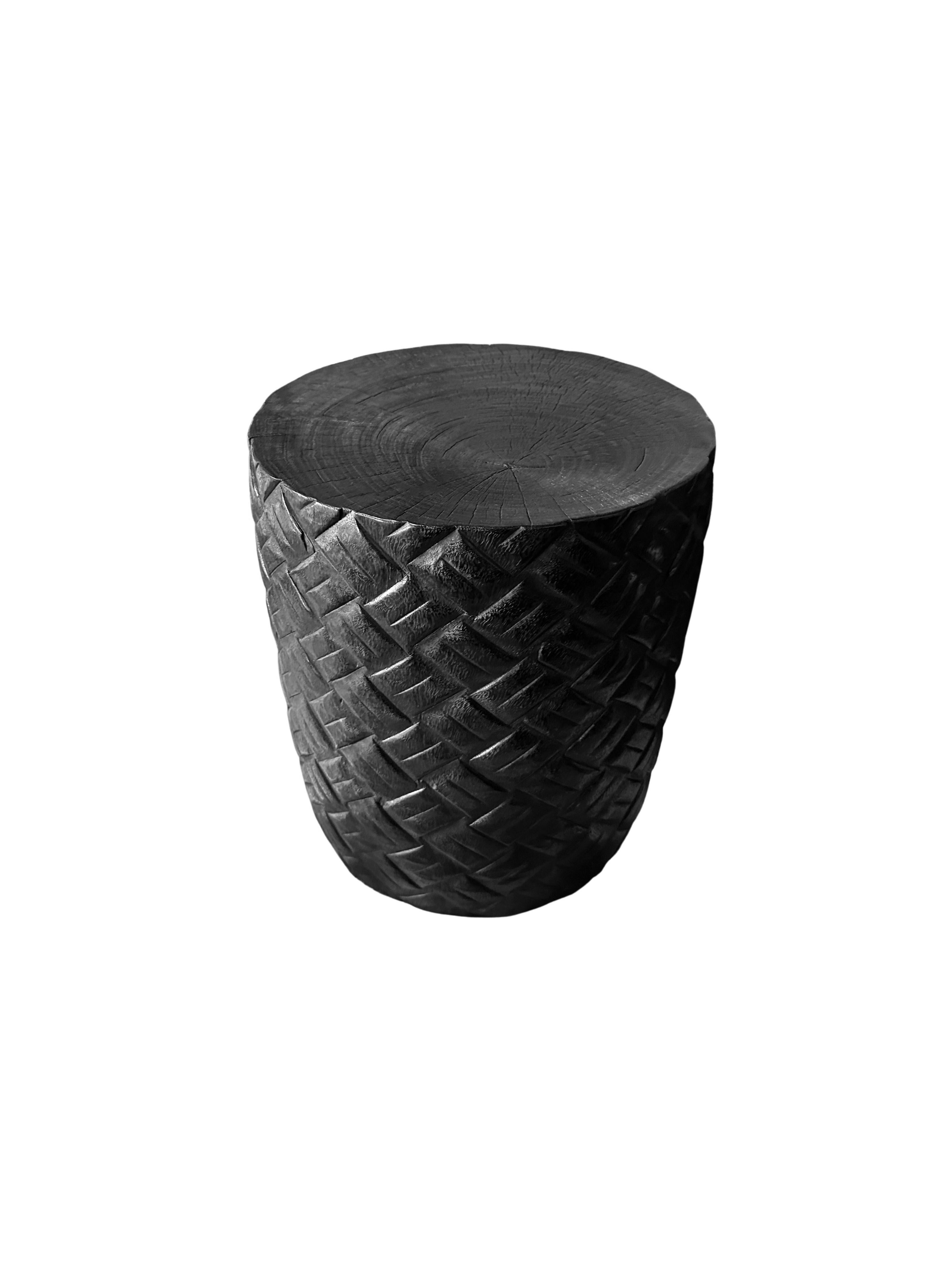 A wonderfully sculptural round side table. Its neutral pigments make it perfect for any space. A uniquely sculptural and versatile piece certain to invoke conversation. It was crafted from a solid block of mango wood and has a smooth texture burnt