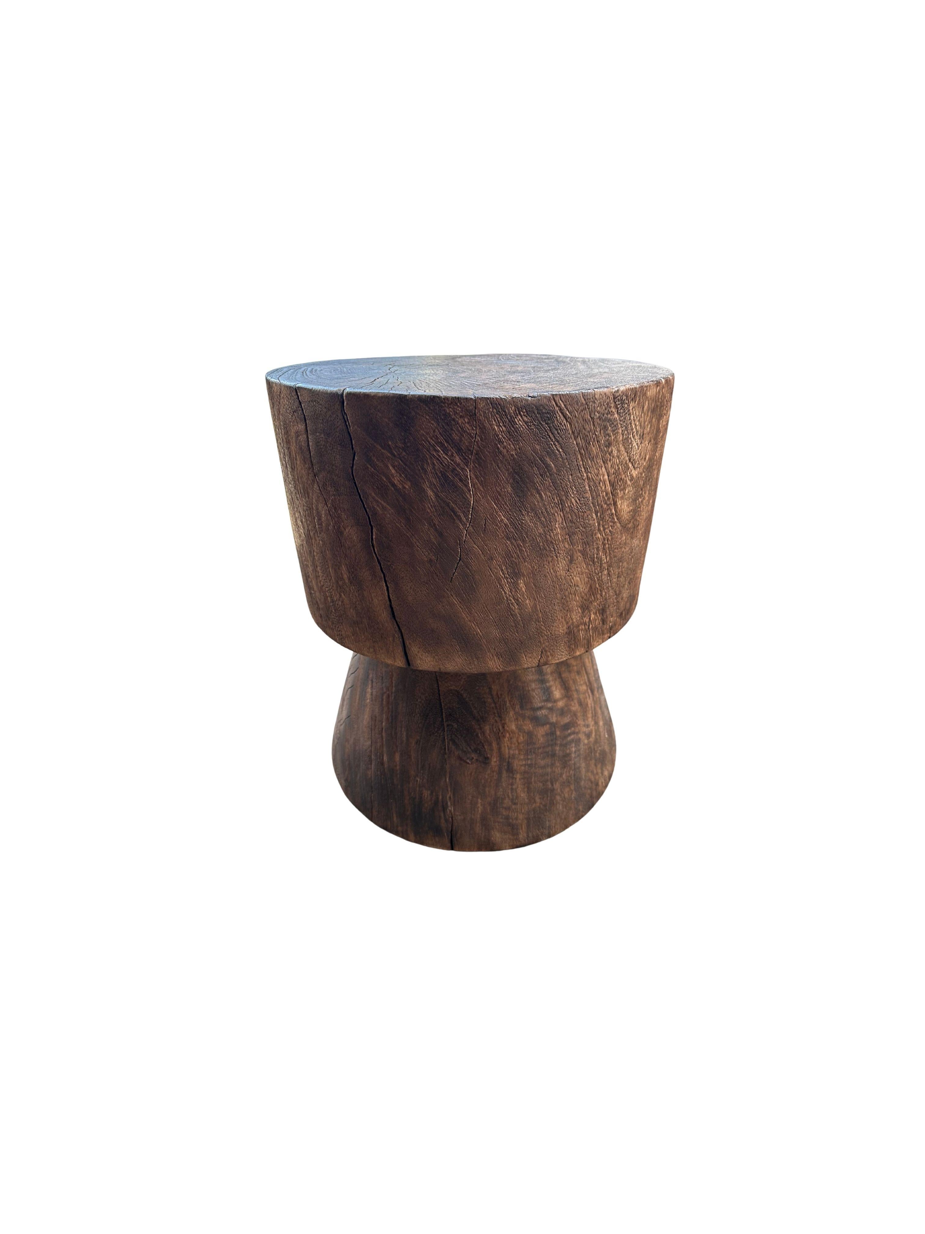 A wonderfully sculptural round side table. Its neutral pigments make it perfect for any space. A uniquely sculptural and versatile piece certain to invoke conversation. It was crafted from a solid block of mango wood and has a smooth texture