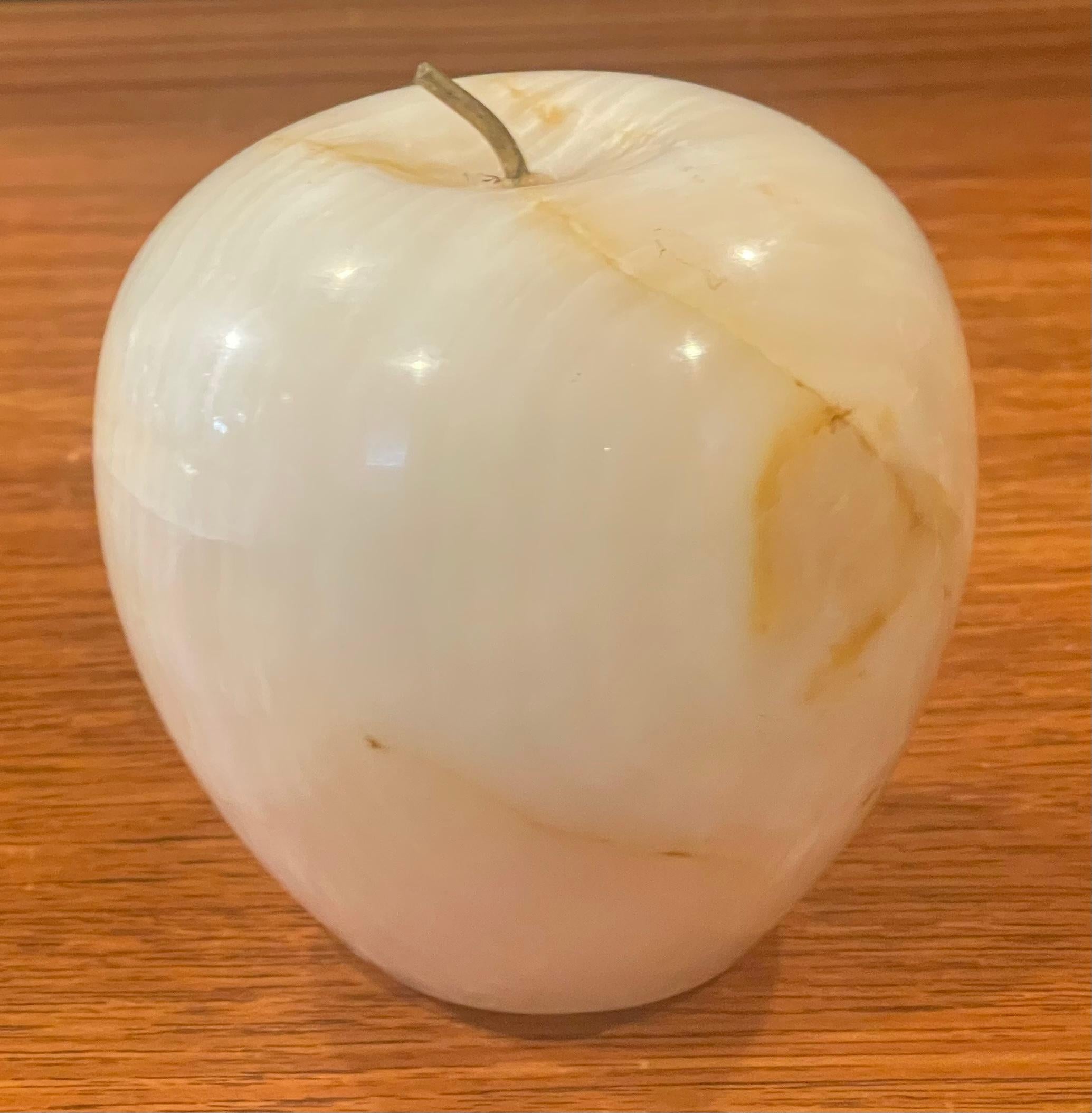 Solid marble with brass accent stem apple paperweight or sculpture, circa 1970s. The piece is in very good vintage condition with no chips or cracks and measures 3.75