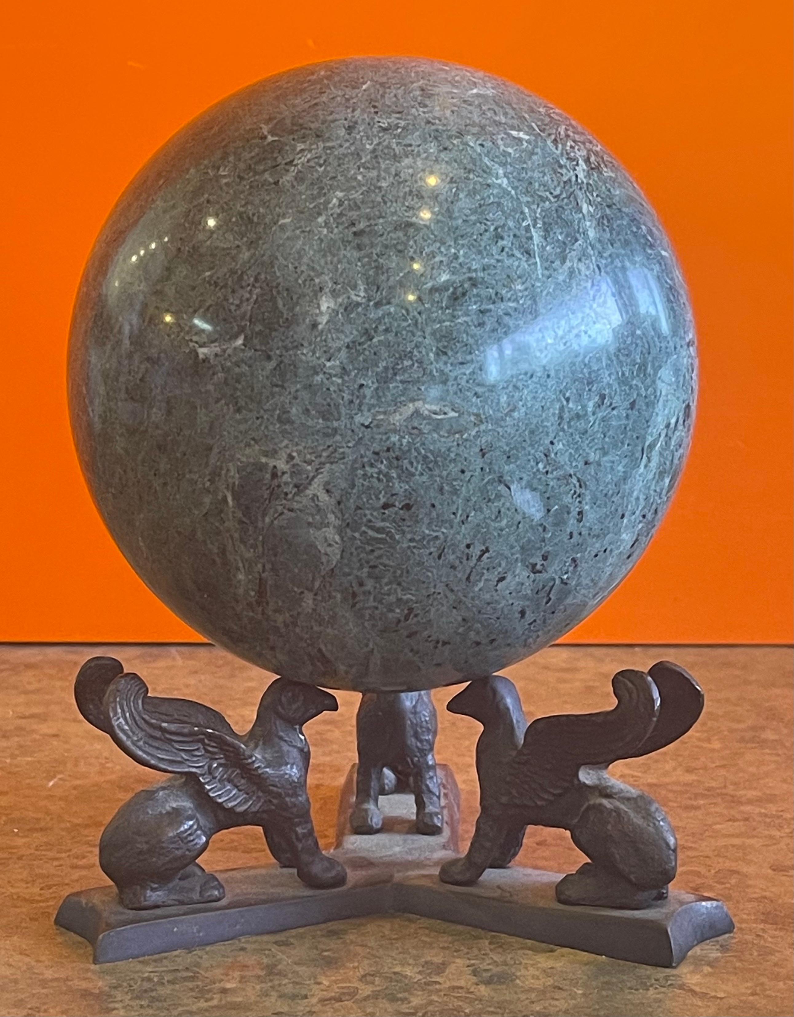 Beautiful solid green marble decorative sphere on bronze base with three griffins, circa 1970s. The piece is in very good condition with no chips or cracks; it has a nice polished finish with with white and grey veining and speckles. The sphere