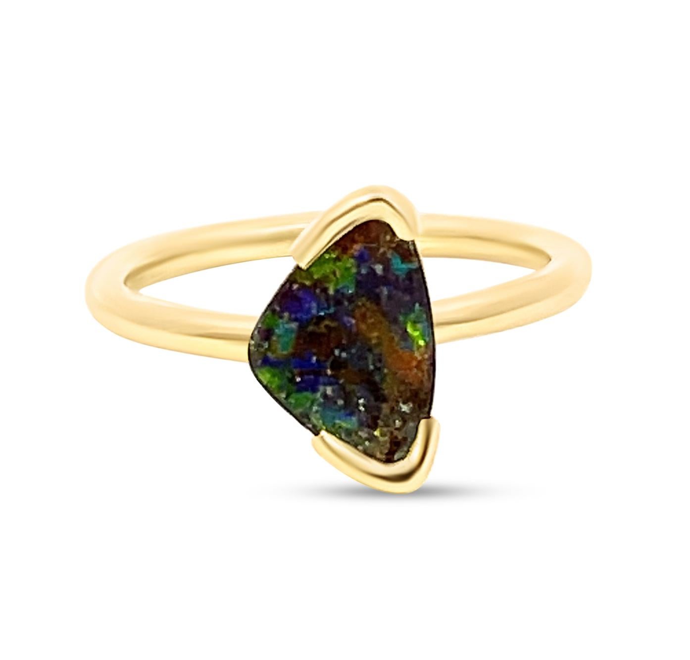 Symbolising wisdom, the ‘Sophie’ engagement opal ring features an elegant boulder opal (1.38ct) ethically sourced from Winton mines in Queensland, Australia. The hues of yellow, juicy green, and navy blue in the gemstone’s play-of-colour express the