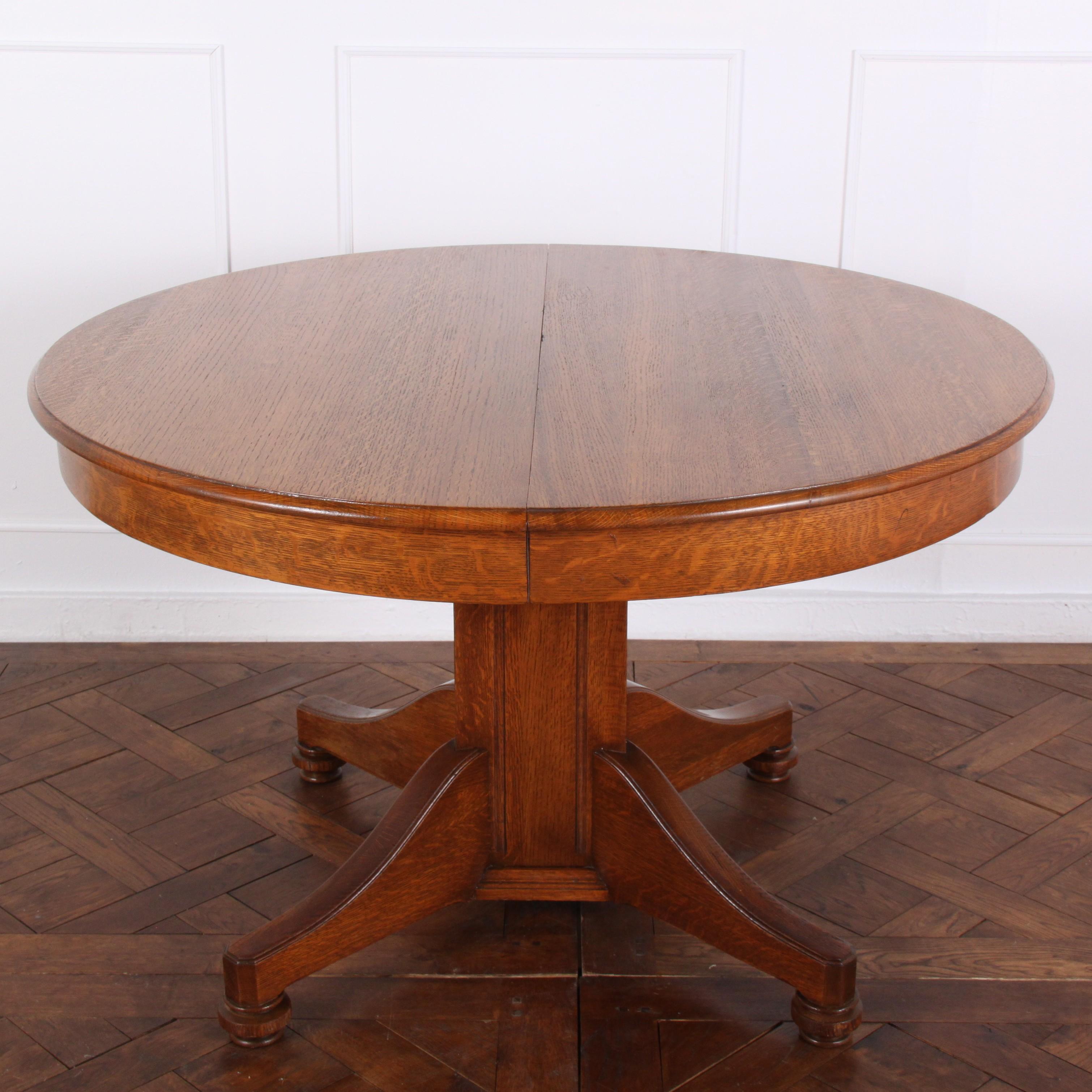 Solid quarter-sawn oak North American-made round Arts & Crafts pedestal dining table with three leaves.
Measures: 45