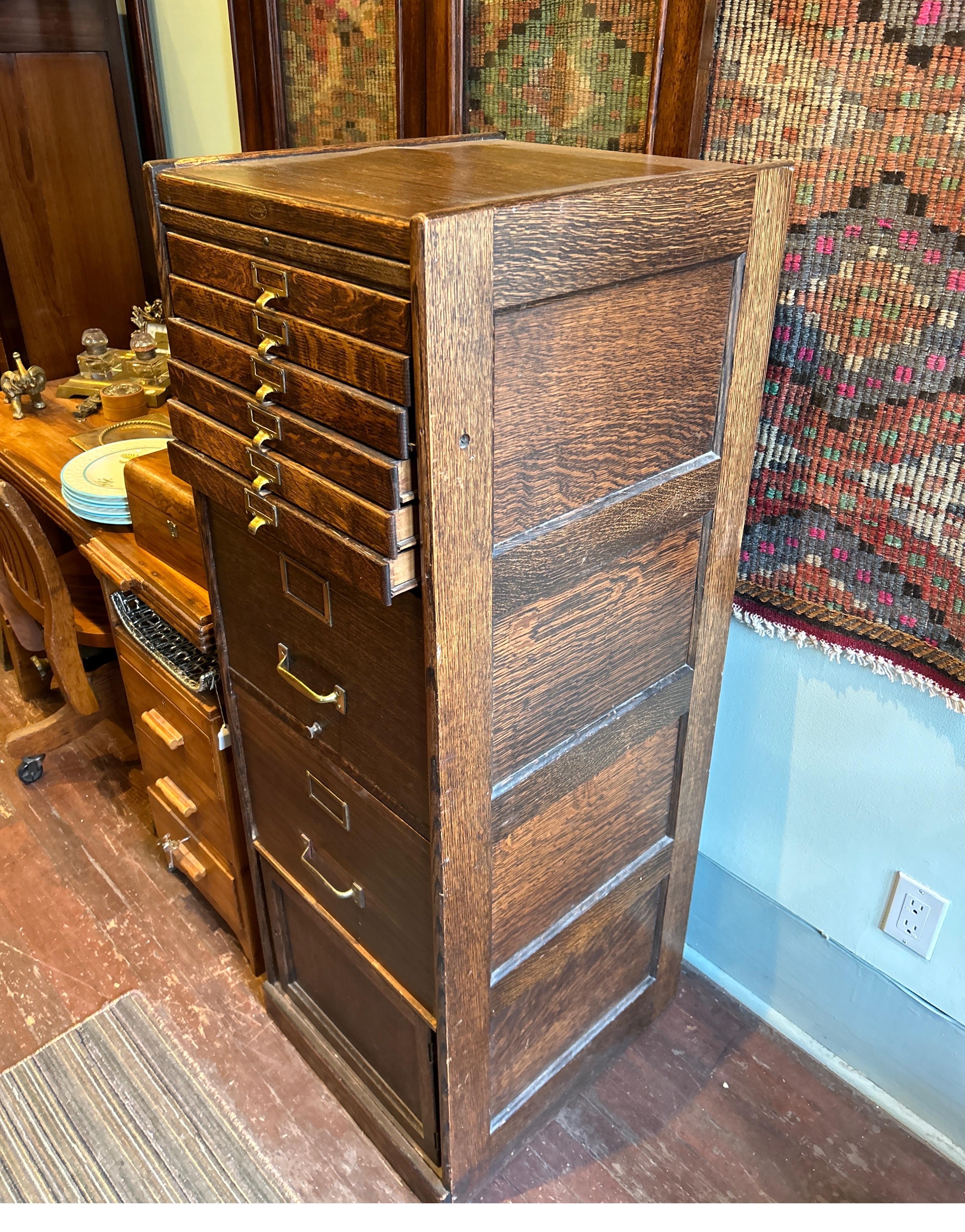 Solid oak Arts & Crafts Barrister cabinet with a unique combination of narrow drawers, larger filings drawers and a cabinet. Excellent patina throughout with original brass pulls and hardware. Nice panel work on the sides. Old world craftsmanship