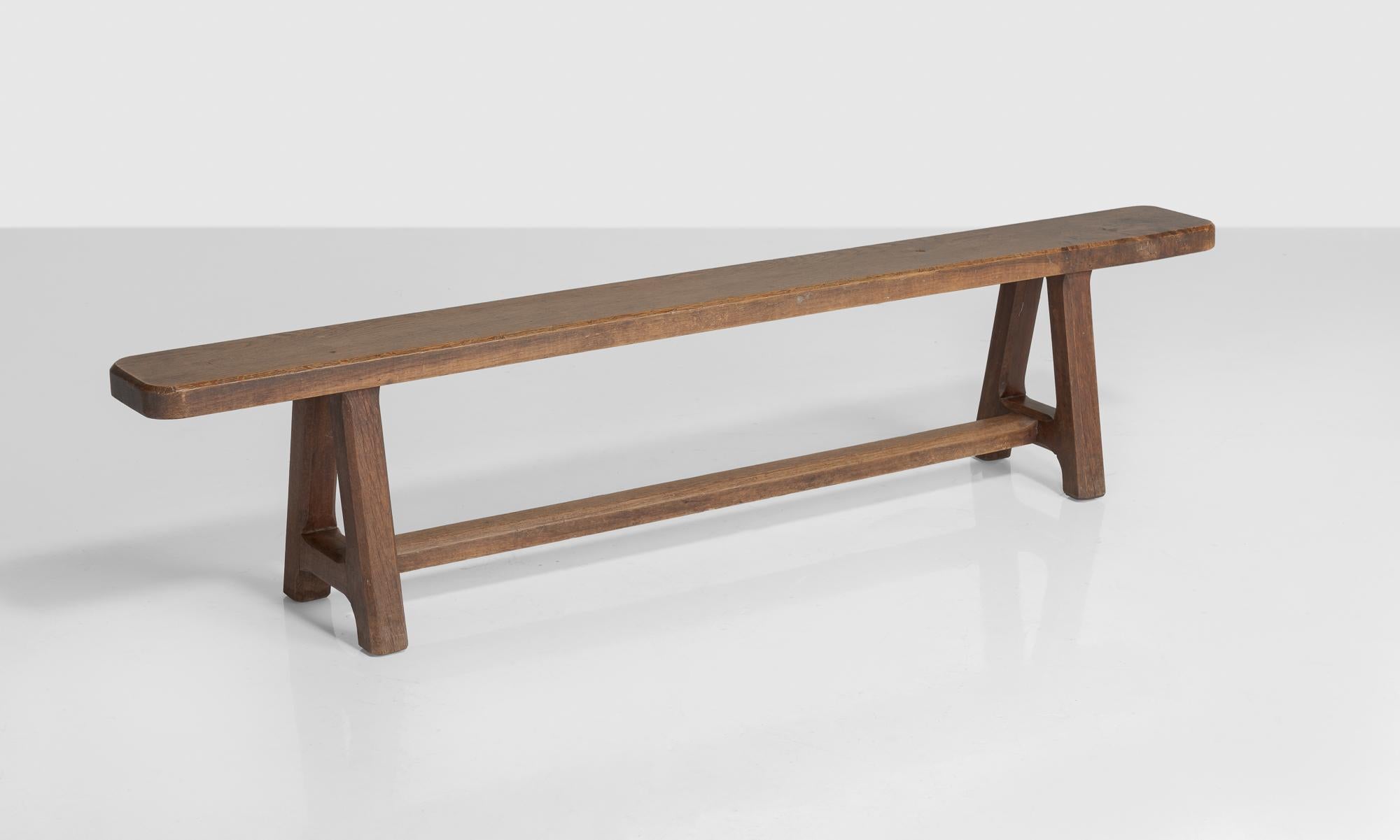 Solid oak bench, England, circa 1850

Thick oak seat on square, chambered legs that are joined by an H-stretcher.