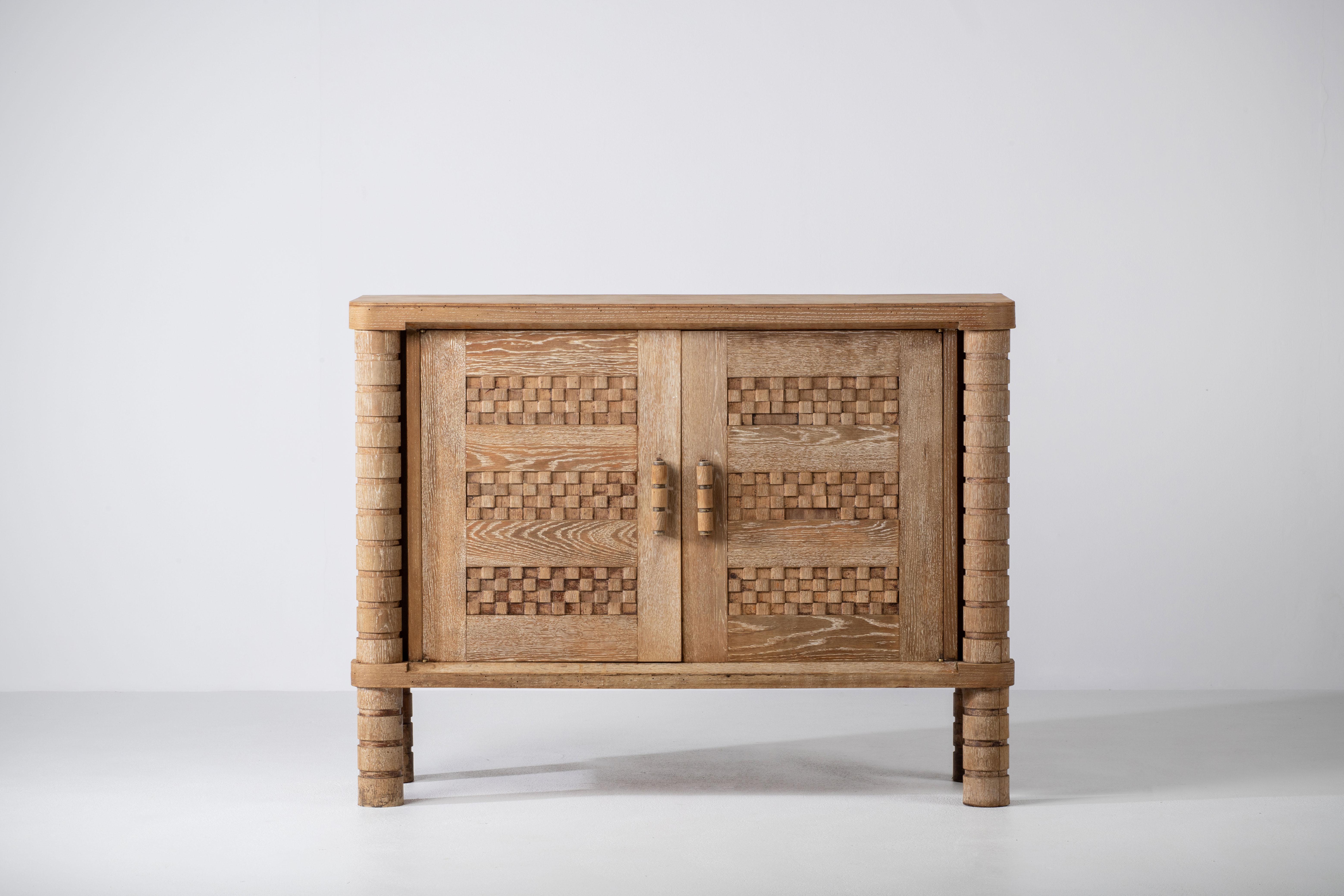 Credenza, solid oak, France, 1940s.
The credenza consists of two storage facilities and covered with very detailed designed doors.
We offer this piece in a bleached finish.
Condition report : Some wooden cubes are missing on the right door.