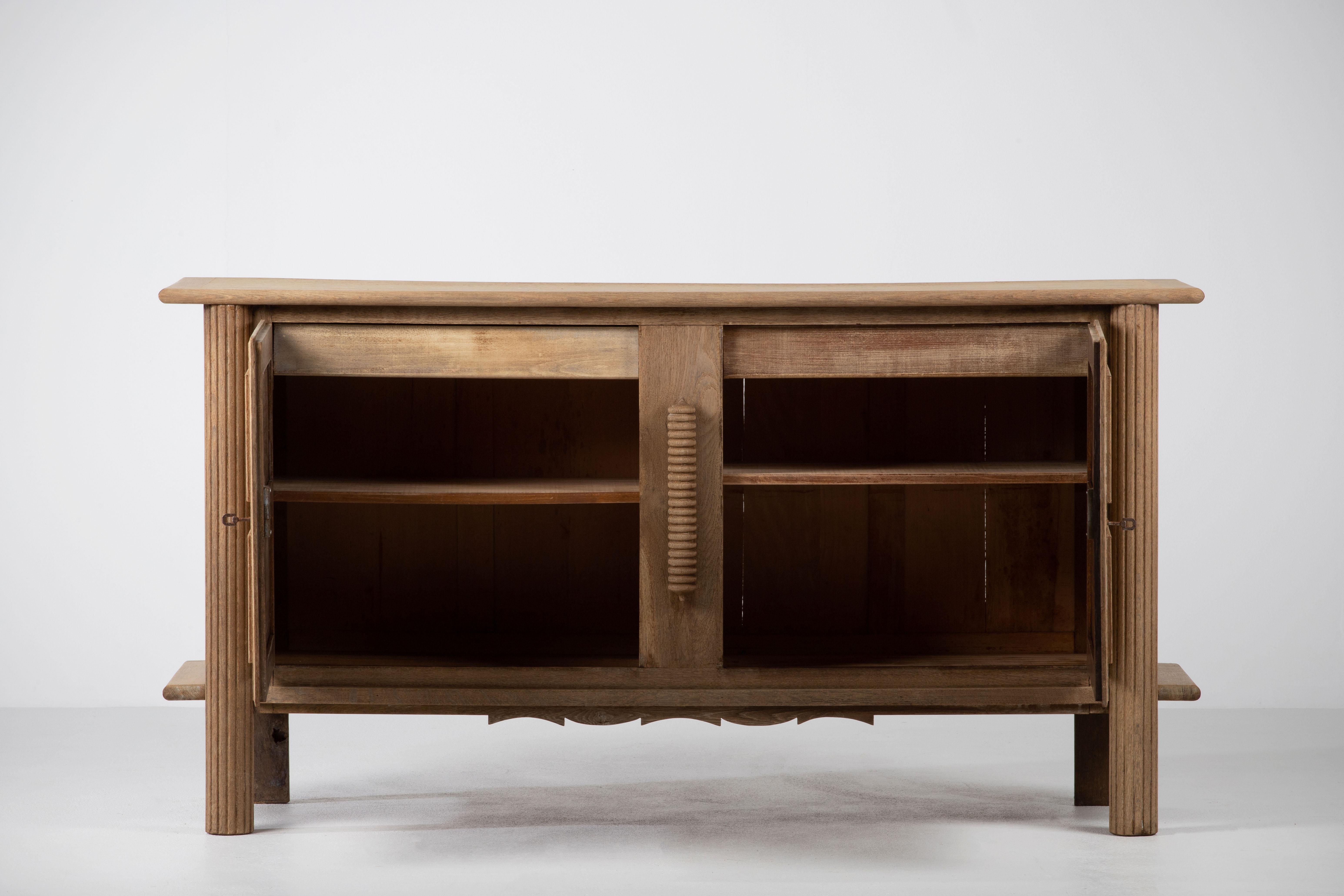 Credenza, solid oak, France, 1940s.
The credenza consists of two storage facilities and covered with very detailed designed doors.
We offer this piece in a bleached finish.