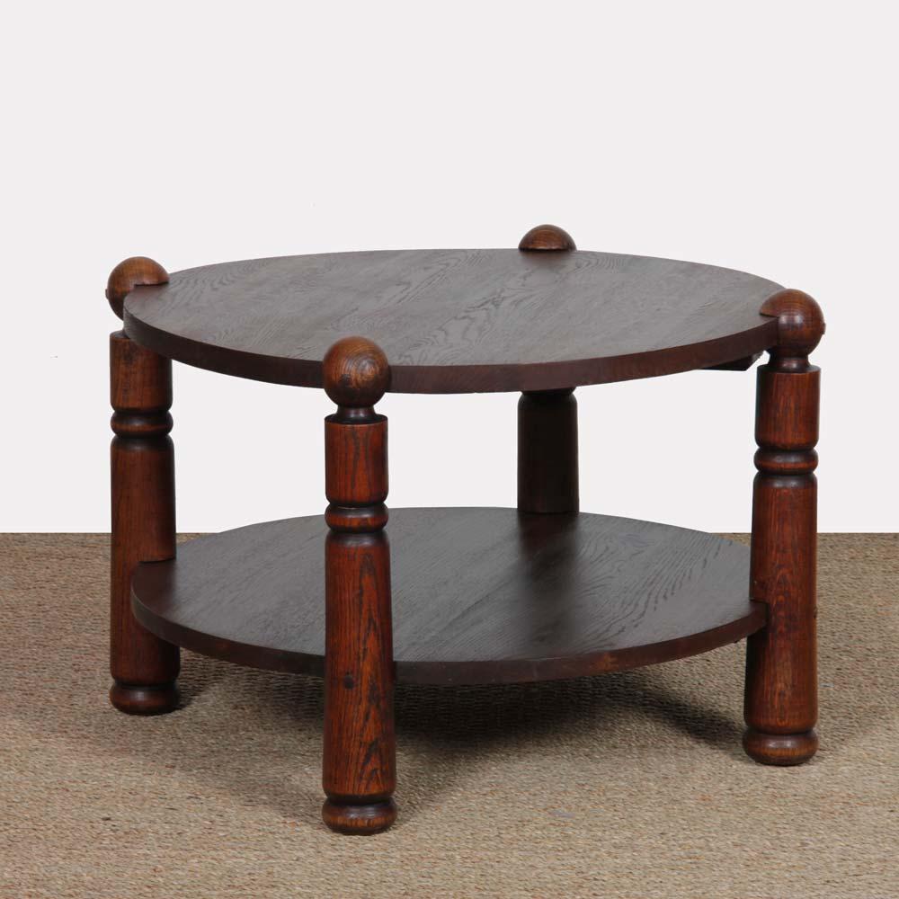 This oak coffee table recalls the work of Charles Dudouyt. It features 2 levels of top. This piece of furniture from the 1950s has been restored. 