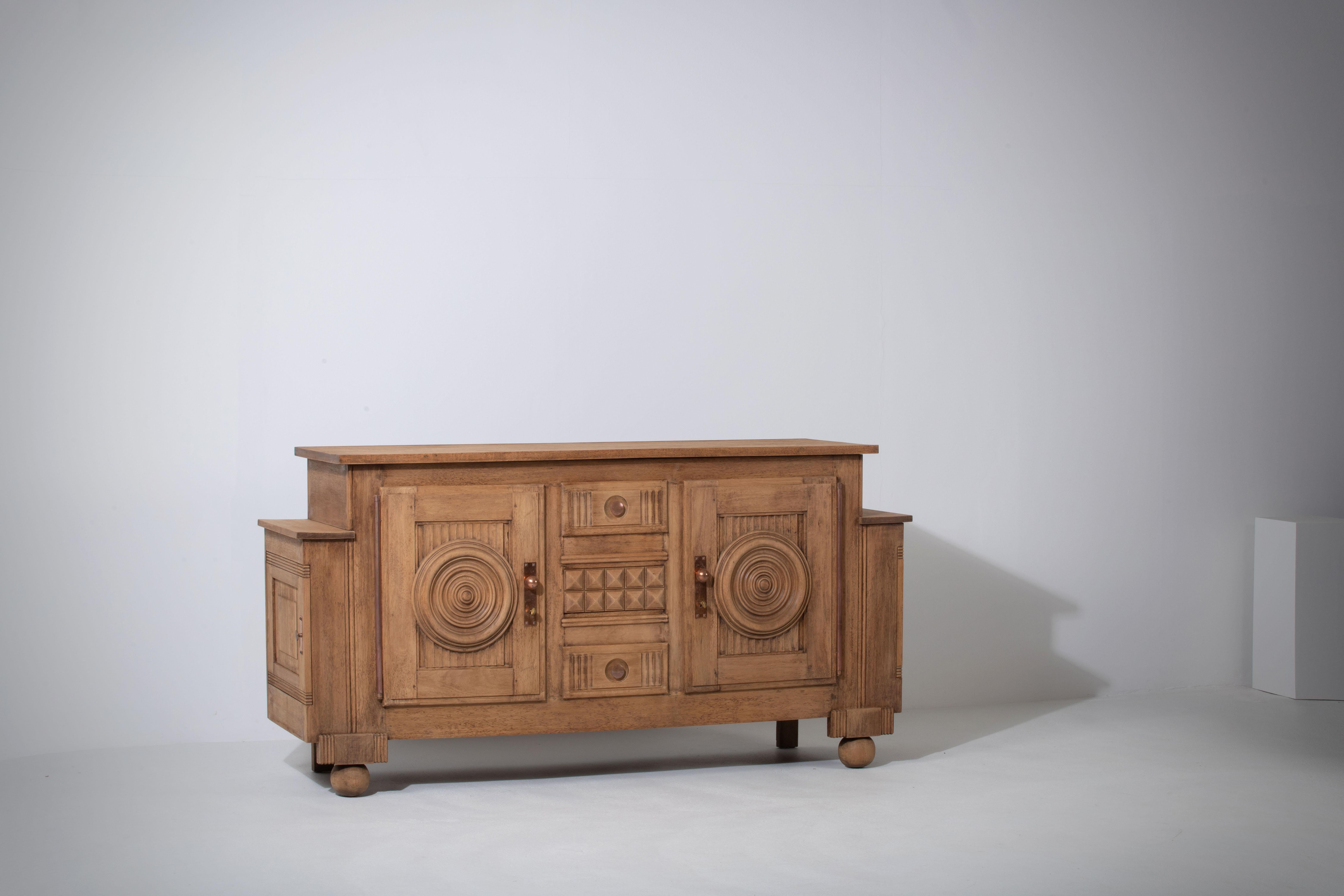 Introducing an extraordinary one-of-a-kind oak sideboard designed by the renowned French designer Charles Dudouyt in the 1940s. Charles Dudouyt was a prominent furniture designer in the early to mid-20th century, known for his remarkable