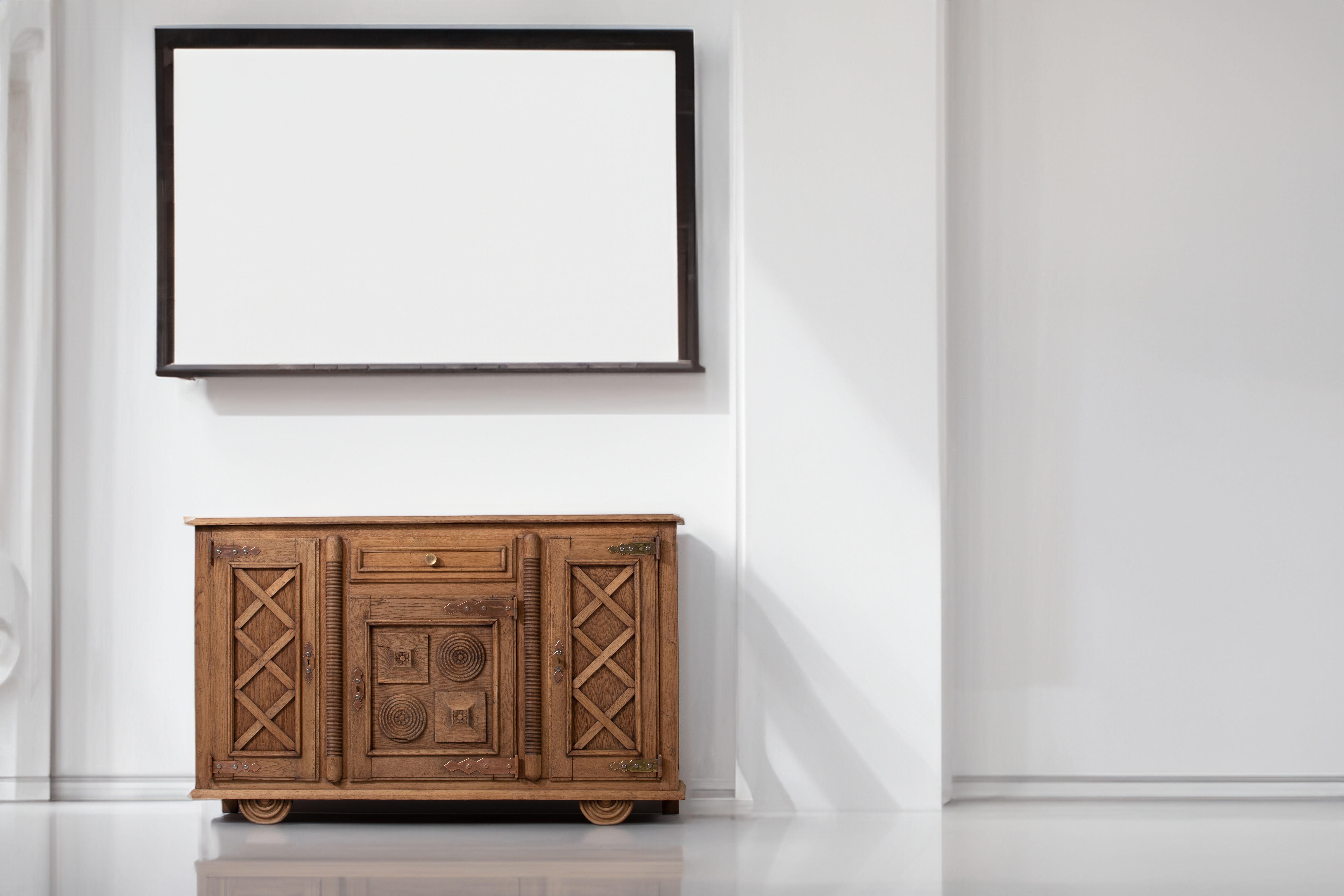 Exquisite French Oak Credenza: A Testament to Charles Dudouyt's Artistry

Immerse yourself in the timeless allure of this French oak credenza, masterfully crafted by the renowned designer Charles Dudouyt in the 1940s. A true embodiment of Art Deco