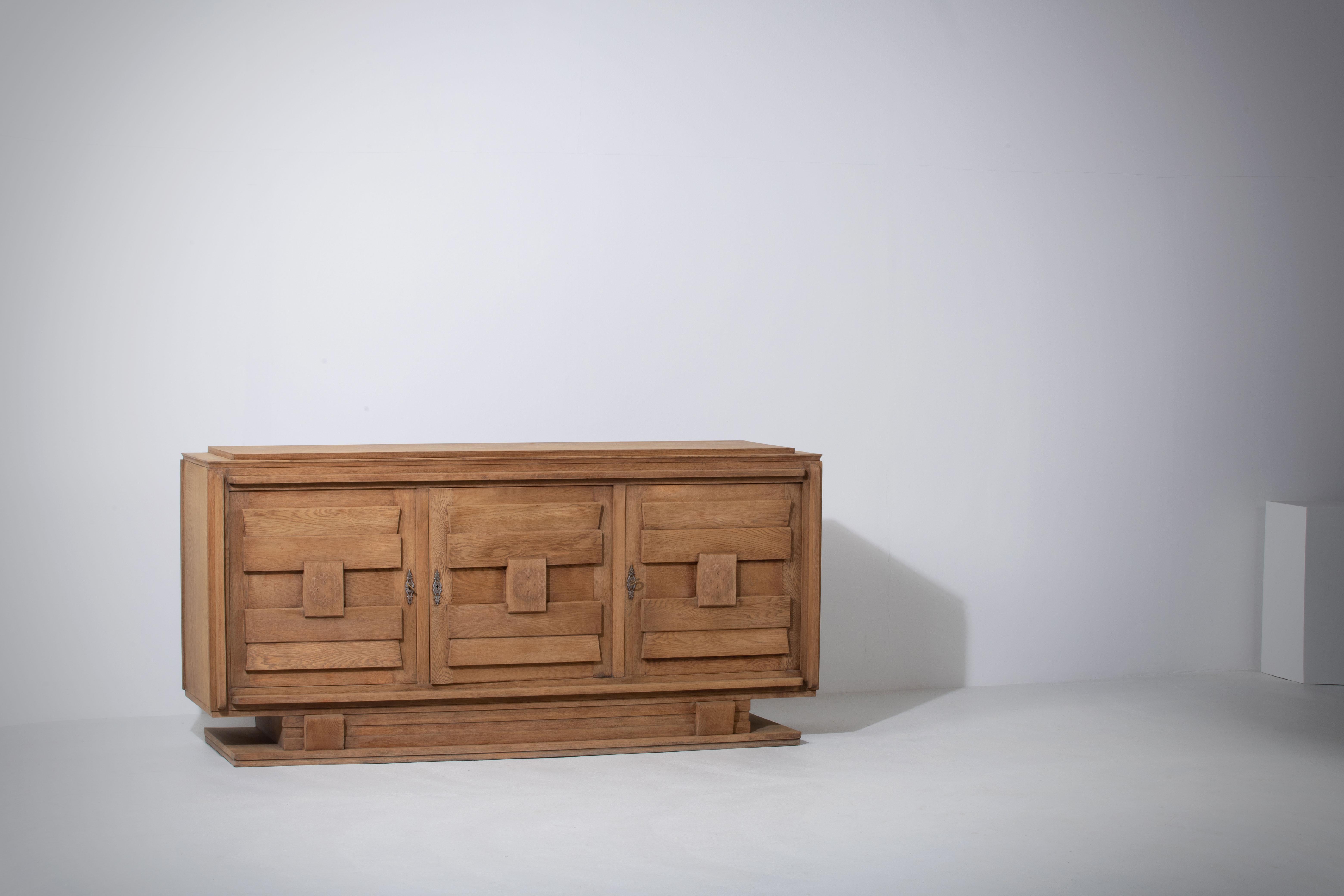 Elegant Credenza, Premium Solid Oak, France, Presumably Charles Dudouyt, 1940s.

Introducing a sophisticated Art Deco Brutalist sideboard, presumably crafted by the renowned French designer Charles Dudouyt in the 1940s. This large credenza,