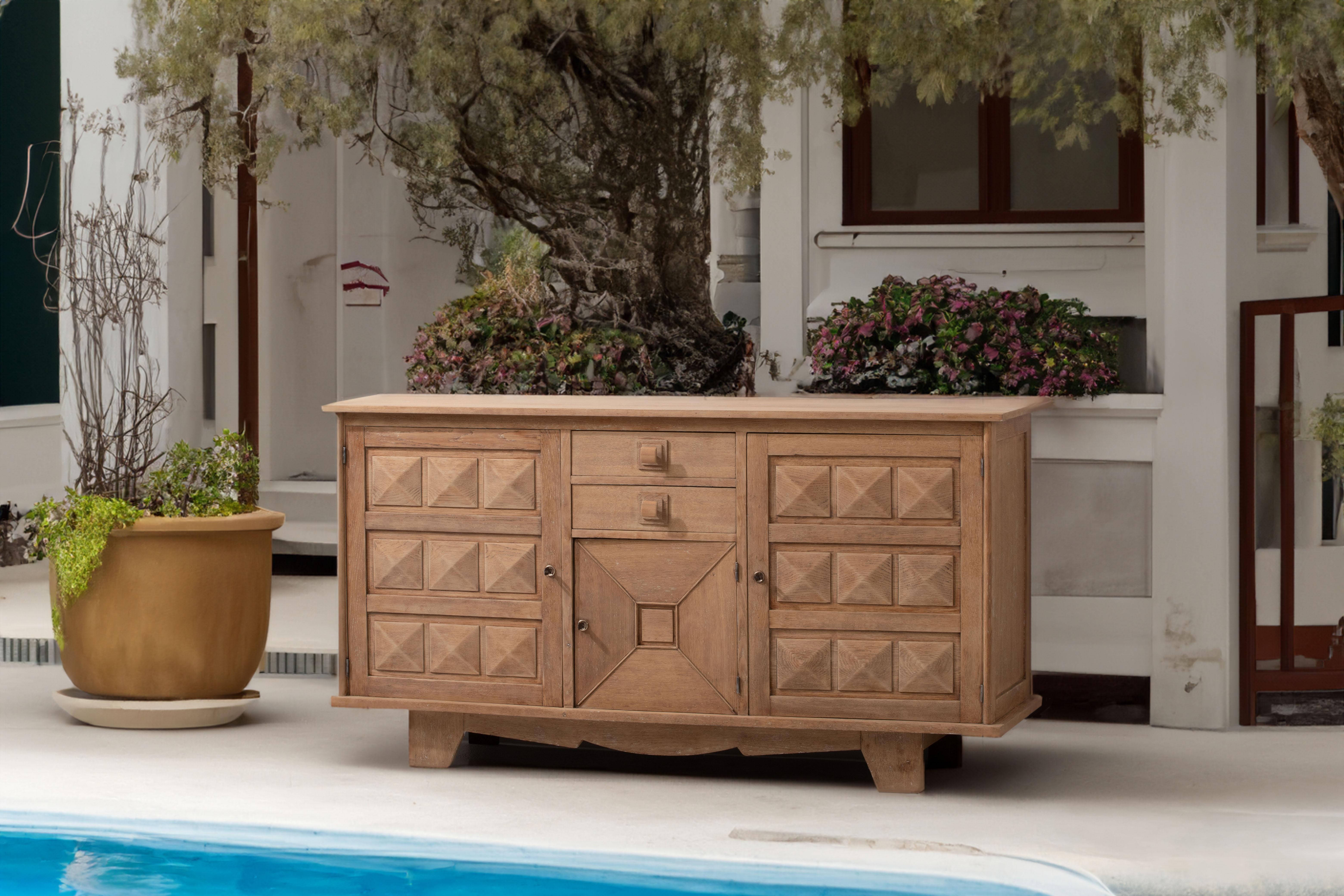 Introducing a captivating cerused credenza inspired by the esteemed French furniture designer, Charles Dudouyt. Renowned for his exceptional craftsmanship and innovative designs, Dudouyt seamlessly blended rustic elegance with modern
