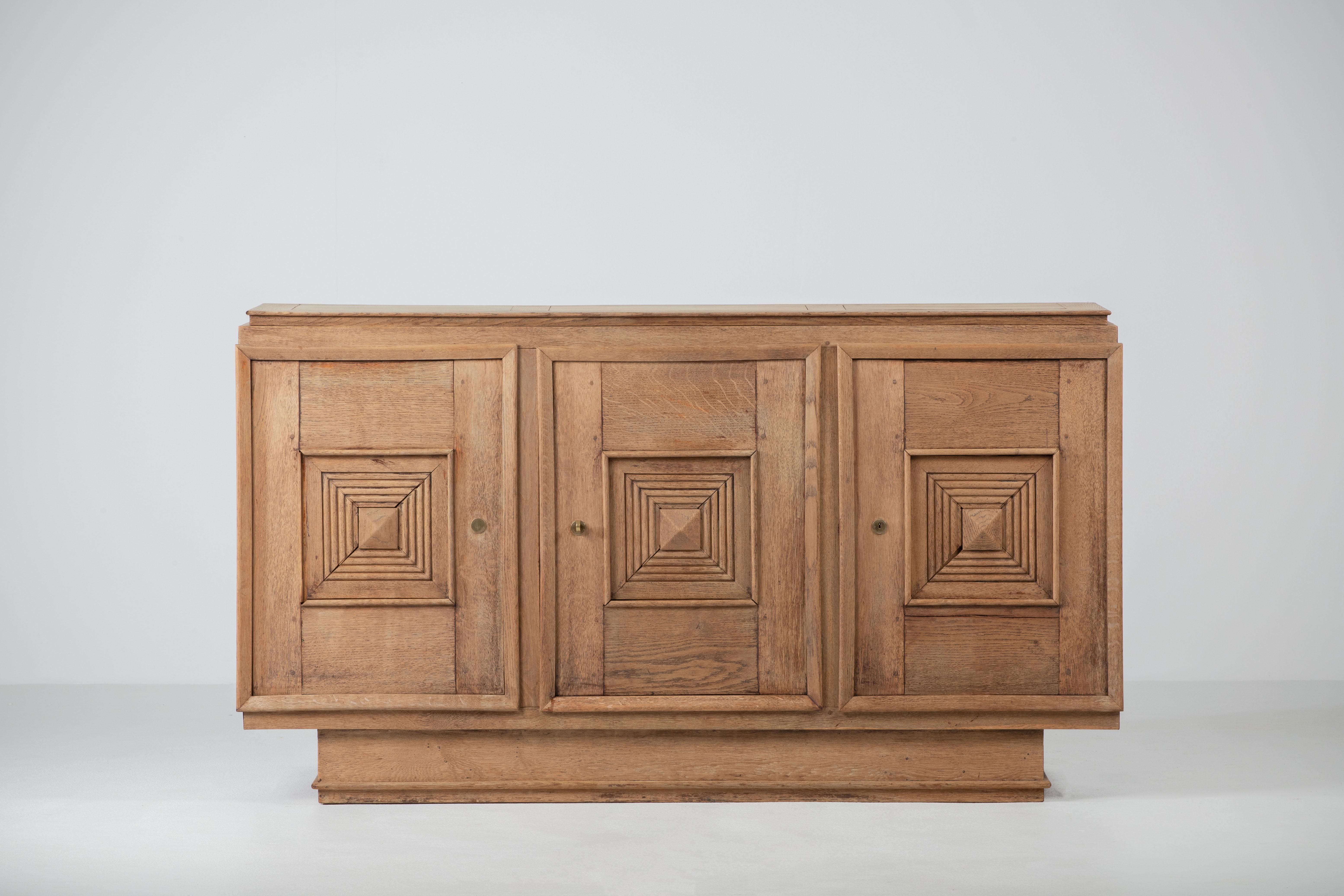 Very elegant Credenza in solid oak, France, 1940s in style of Maxime Old.
The credenza consists of three storage facilities covered with very detailed designed doors. 
Very elegant.
 