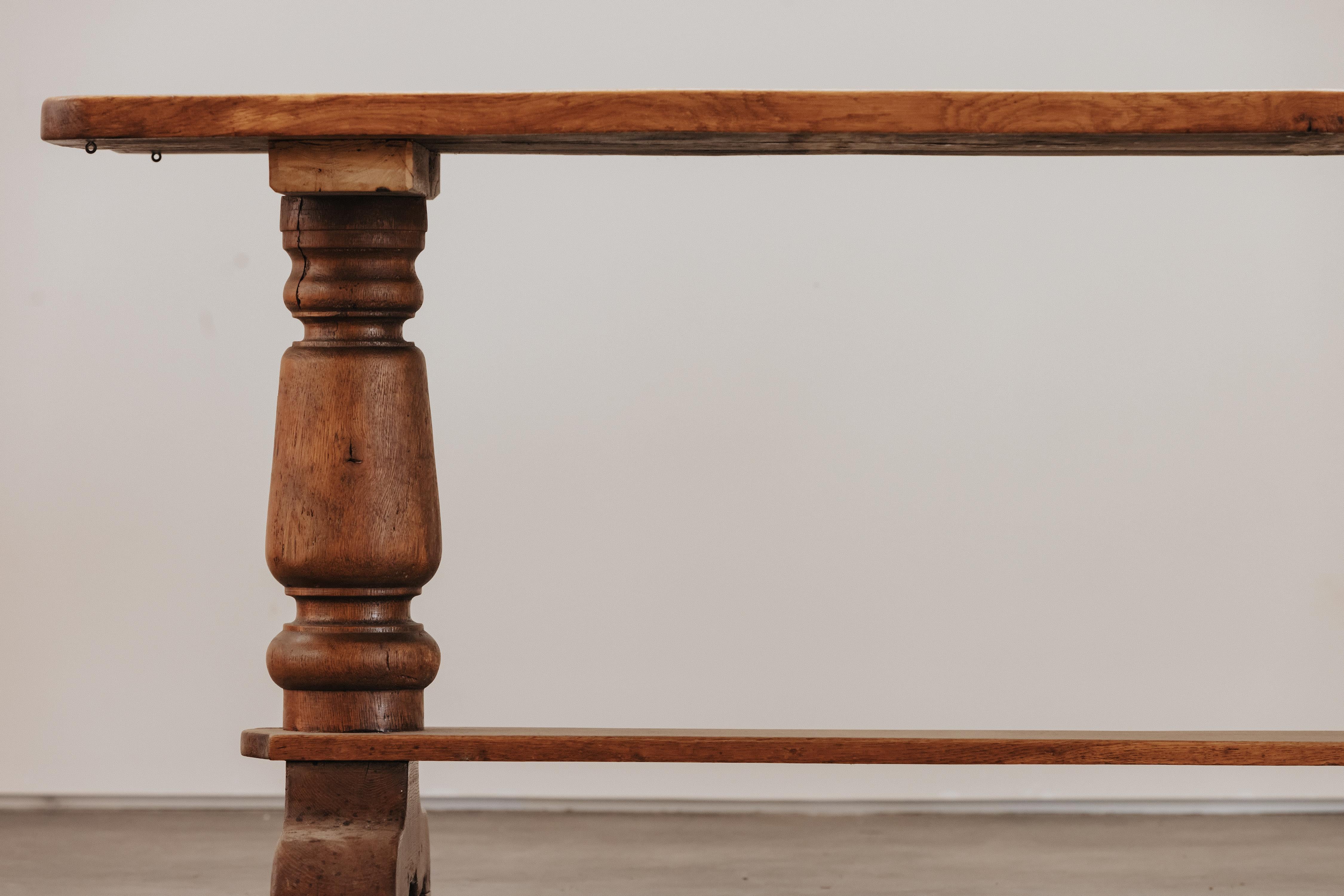 Solid Oak Dining Table From France, Circa 1950.  Solid oak construction with nice curved base.  Nice patina and use.

