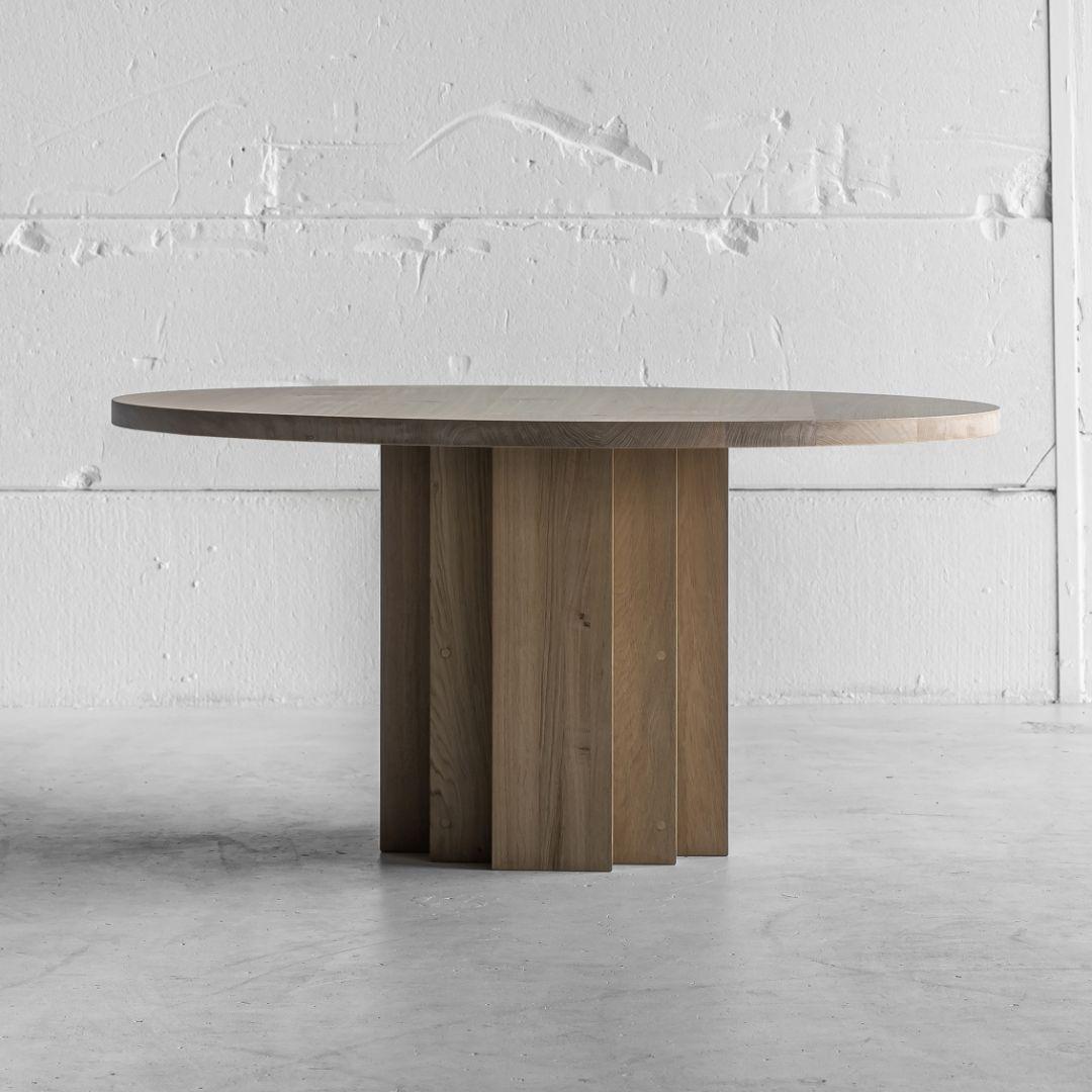 This sculptural yet minimalist table epitomises modern sophistication and timeless elegance. It is at dining table height but would work in a multitude of spaces. 

Handcrafted from solid oak the table top has a simple, contemporary design with a