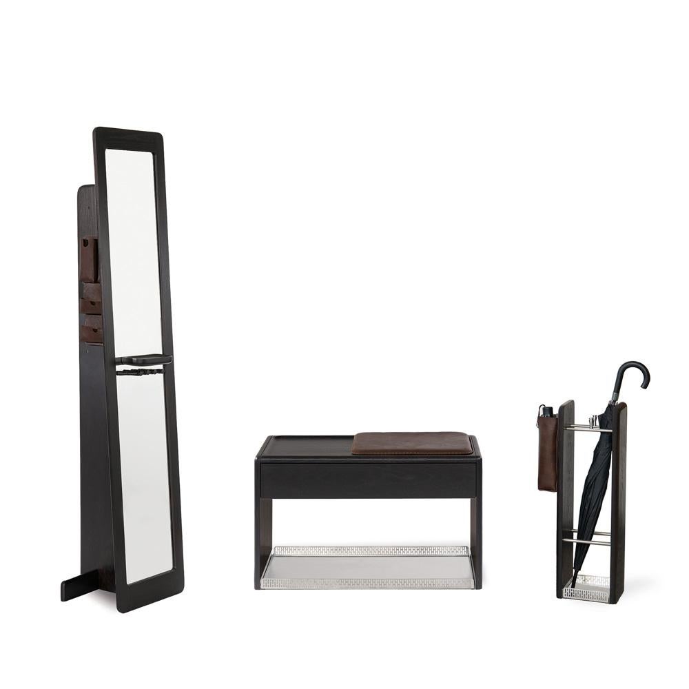 The HOL Series entryway set with leather and chrome details is a refined ensemble that brings together the natural beauty of oak wood and the elegance of handcrafted design. Consisting of a mirror, bench, and umbrella stand, this set offers a