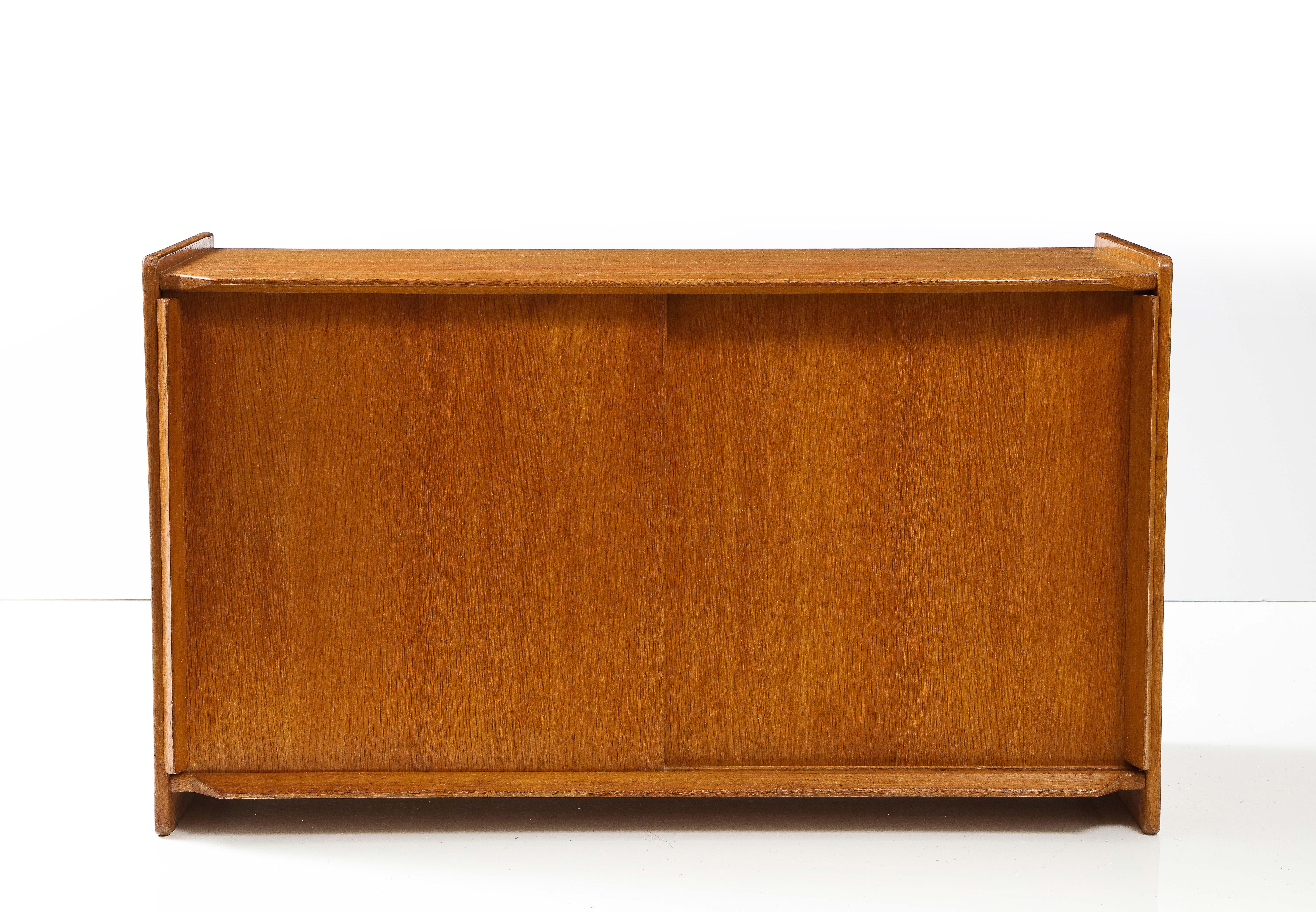 Solid Oak French Modernist low sideboard, France, c. 1960
Oak, Note: Interior shelf with small drawer
Measures: H: 28 D: 17.5 W: 49 inches.