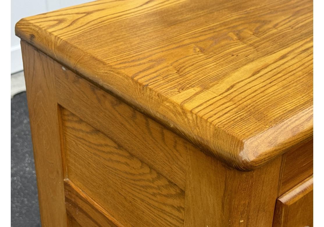 A very well made early 20th Century solid Oak ice box manufactured by Biltwell and sold exclusively through Abraham & Strauss, Brooklyn, New York. With beautifully finished wood and handsome graining and paneled sides, the ice box has three doors