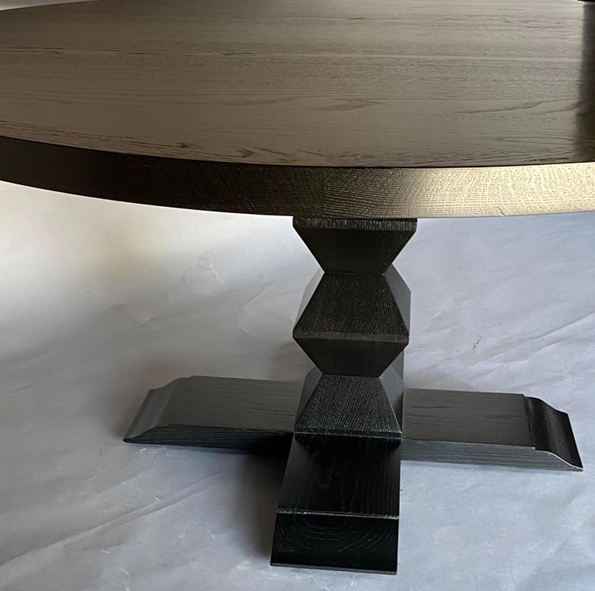 In stock: Our custom Portuguese pedestal table in solid Oak. Two inch framed top. Beautiful ebony finish where the grain is still visible. This table is available off the floor but can also be custom made in other sizes and finishes. 
Made in Los