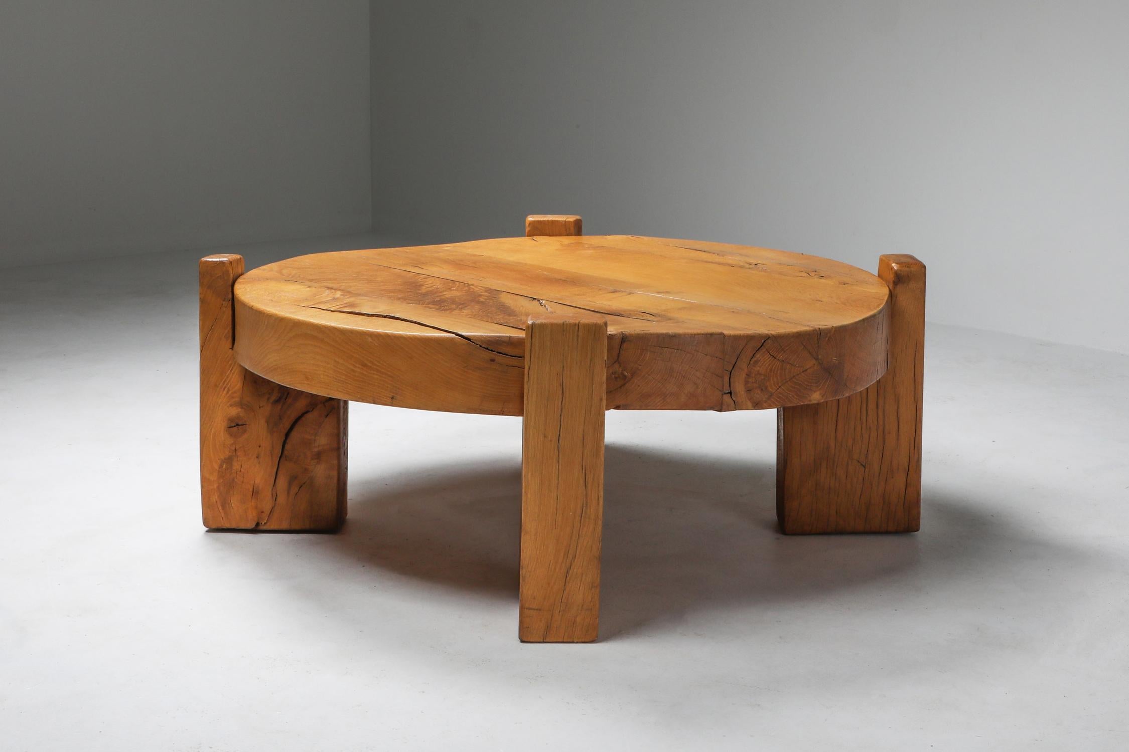 Rustic modern round coffee table in solid oak with four legs, made in Europe, 1960s. Would fit well in a Pierre Chapo inspired interior.
Integrates Brutalist and wabi sabi qualities in one piece.

 