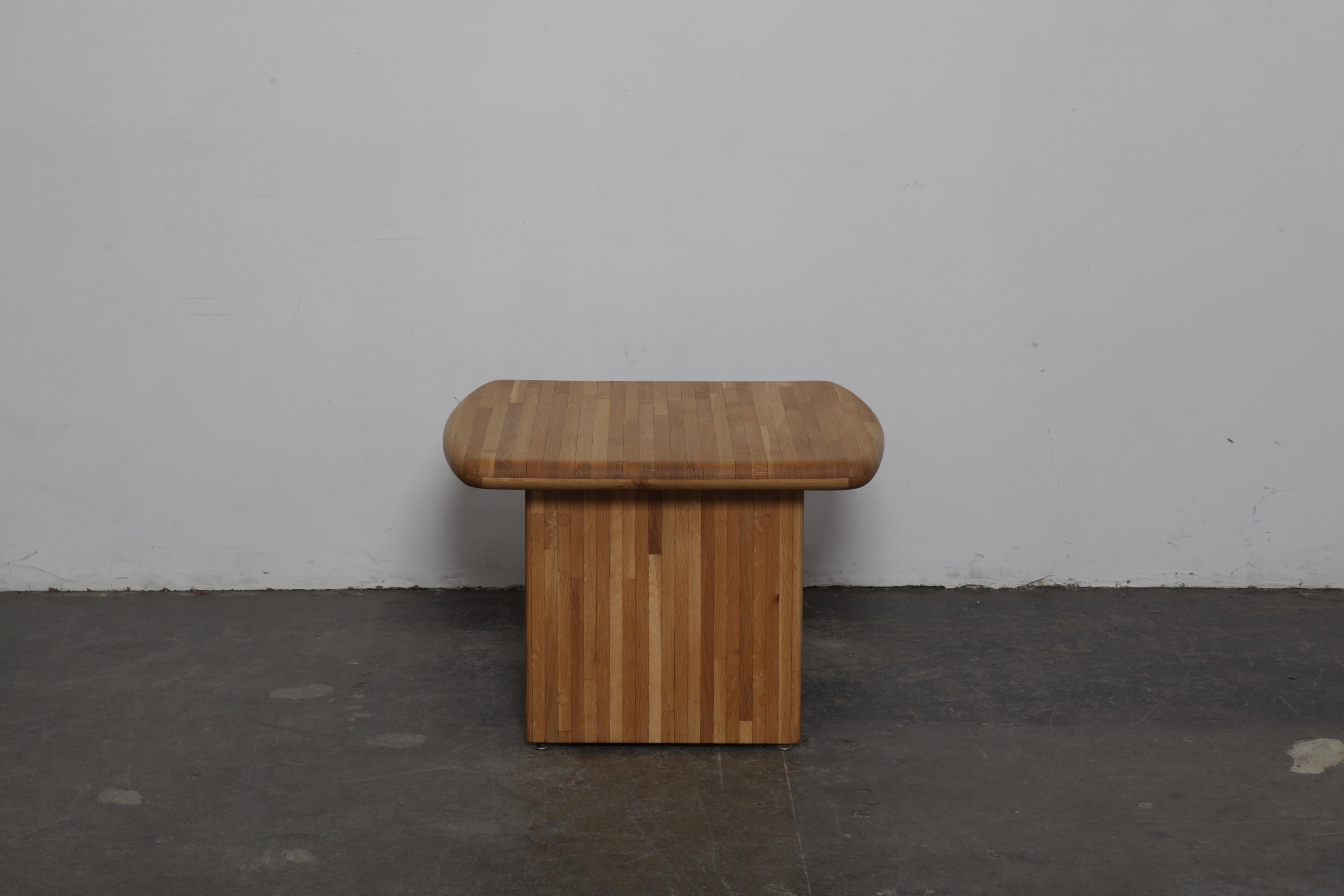 Solid oak California modern coffee table, design attributed to Lou Hodges, USA, 1970s, newly refinished in a satin lacquer. Table has a rounded corner square top with double wood legs.