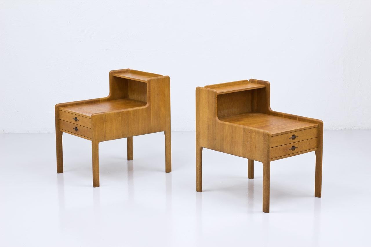 Pair of large and heavy side, bedside tables from unknown maker. 
Most likely manufactured in Sweden during the 1960s. 
Made from solid oak with steel pull handles.

Good vintage condition with some signs of wear.