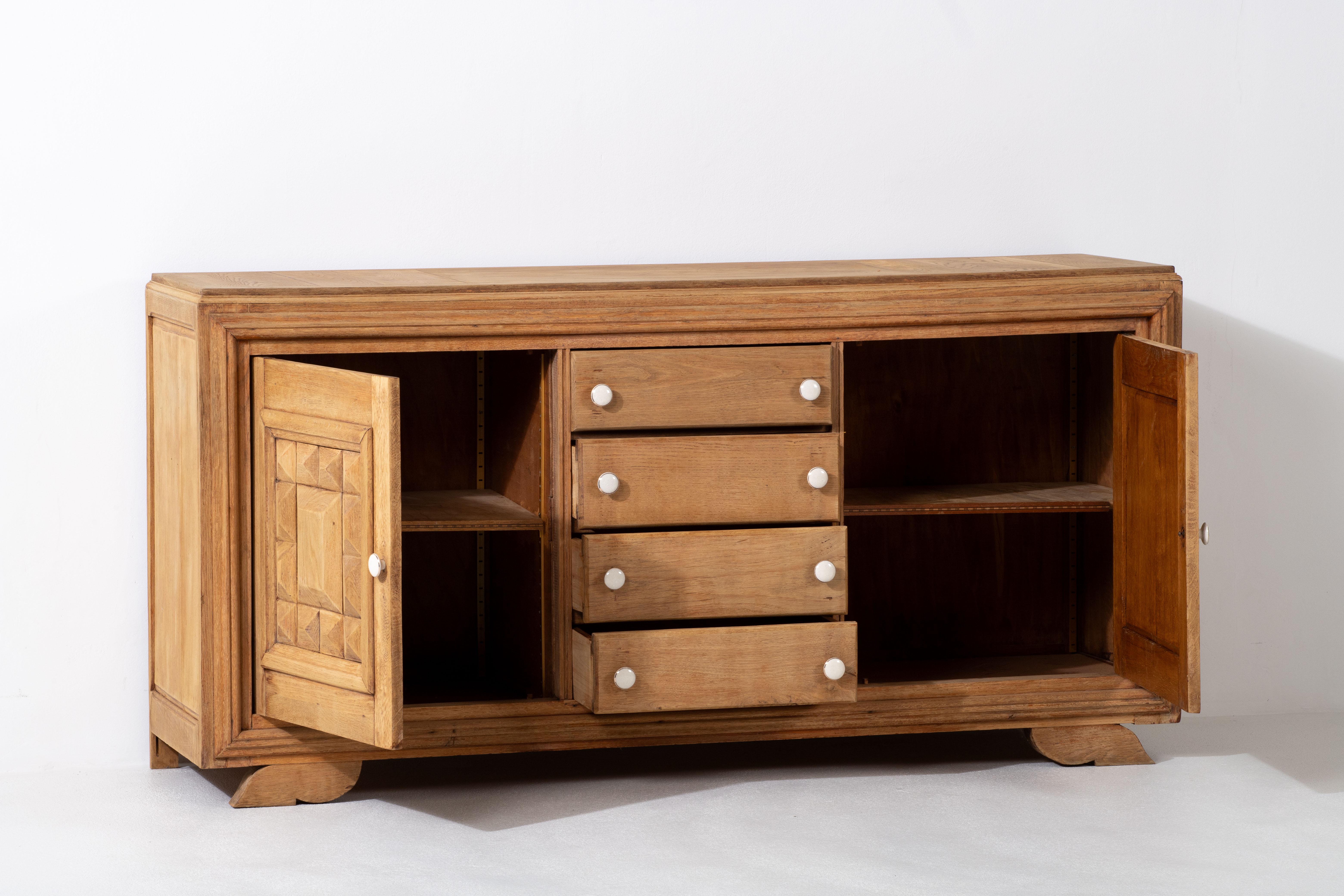 Unveil the epitome of elegance with this exquisite sideboard, meticulously crafted from natural oak, capturing the essence of France's rich heritage. The symmetrical arrangement of graphical doors and the central column of drawers evoke a sense of