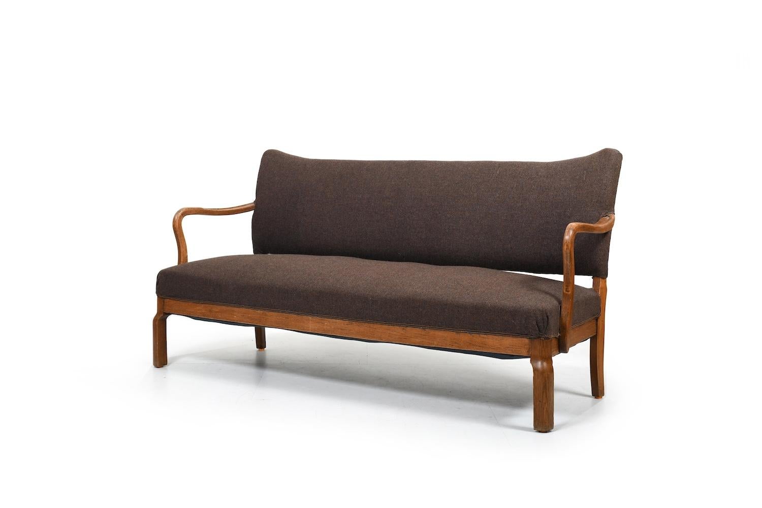 Rarely offered Slagelse Møbelværk sofa in sold oak and brown wool fabric. Produced in 1930s. In good vintage condition, with nice old patinated oak.