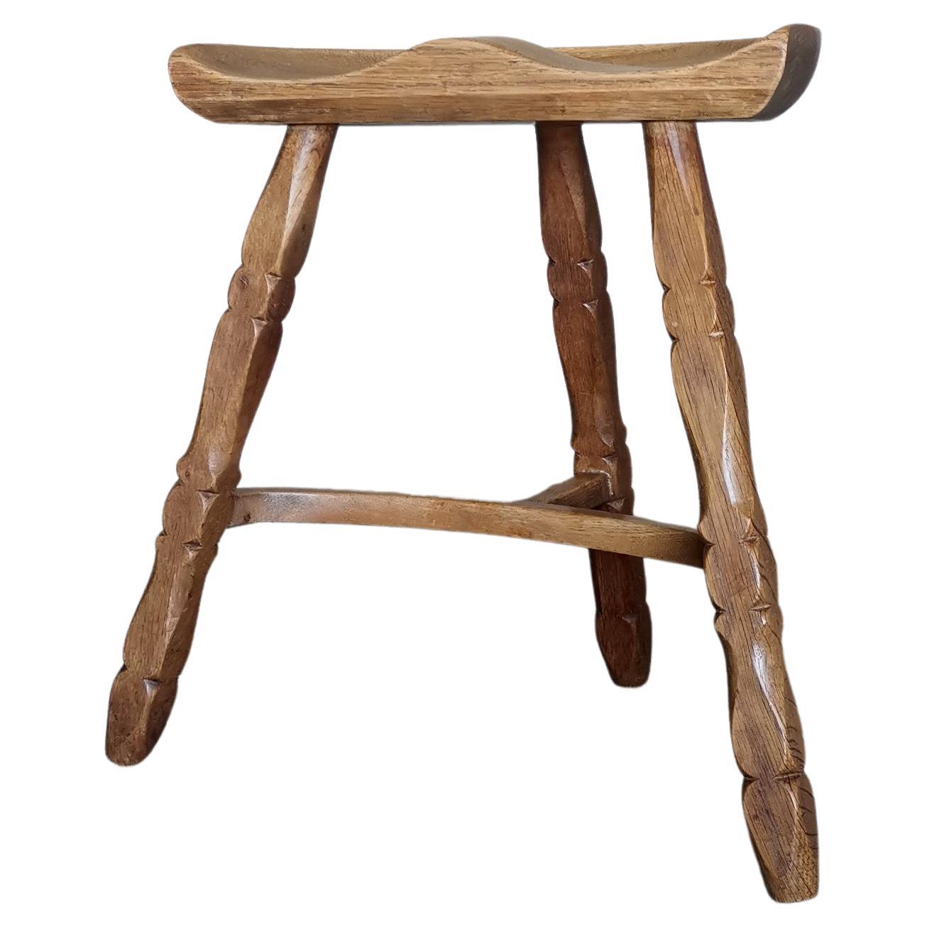 Solid oak stool in style of Henning Kjærnulf, hand sculpted seat, Denmark 1960s  For Sale