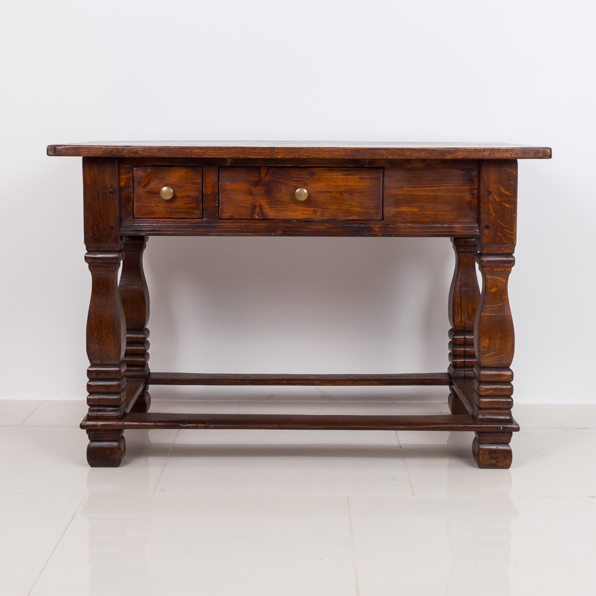 This gorgeous antique table was made around late 18th or early 19th Century. The whole piece is made of solid oak. Six wide oak boards comprise the table’s top. The top is set on a solid base with a wide apron that reveals two drawers for practical
