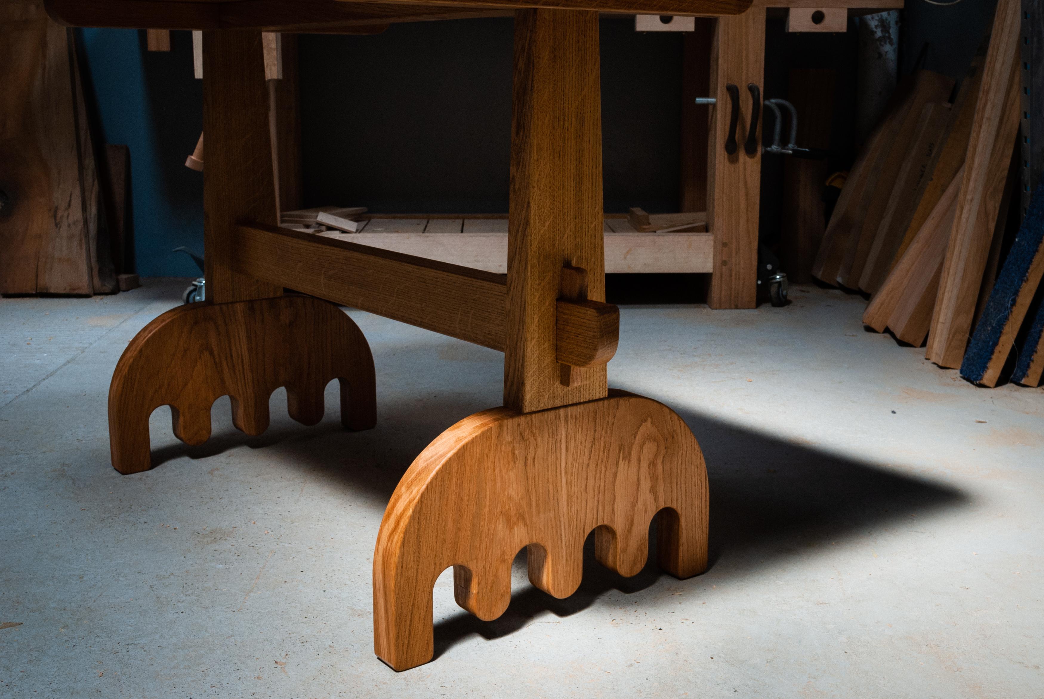 Solid English Oak Dining Table with wedged mortice and tenon joints on the legs and wiggly feet. Based on traditional construction, with a chunkier and playful twist.

This table is made from solid timber, intelligent use of joinery pulls the form