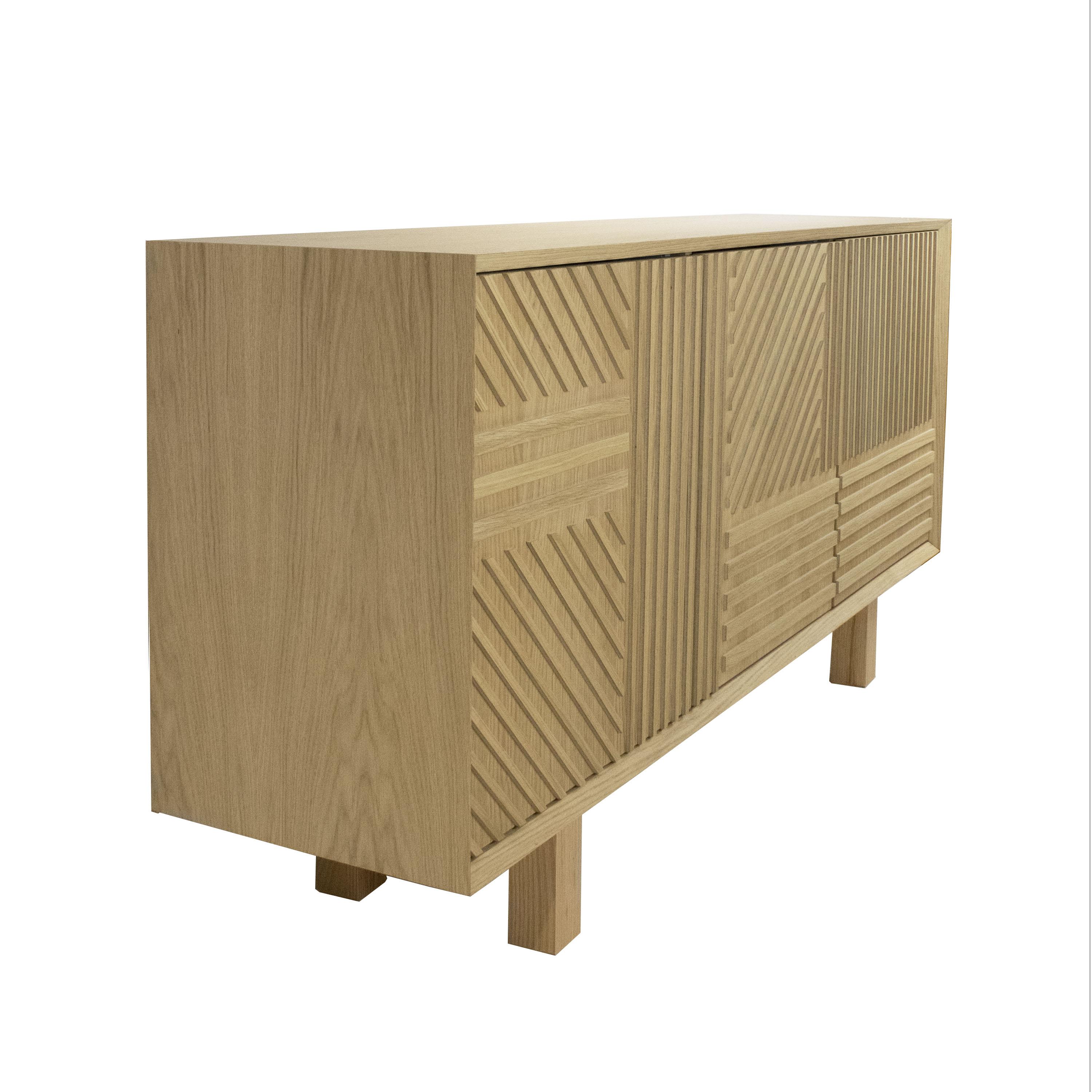 Handcrafted sideboard designed by IKB 191 studio. It consists of a solid oak structure with three doors decorated with a linear wood grid and a click-tight closure. Storage space is provided in the inner part, which is divided into three
