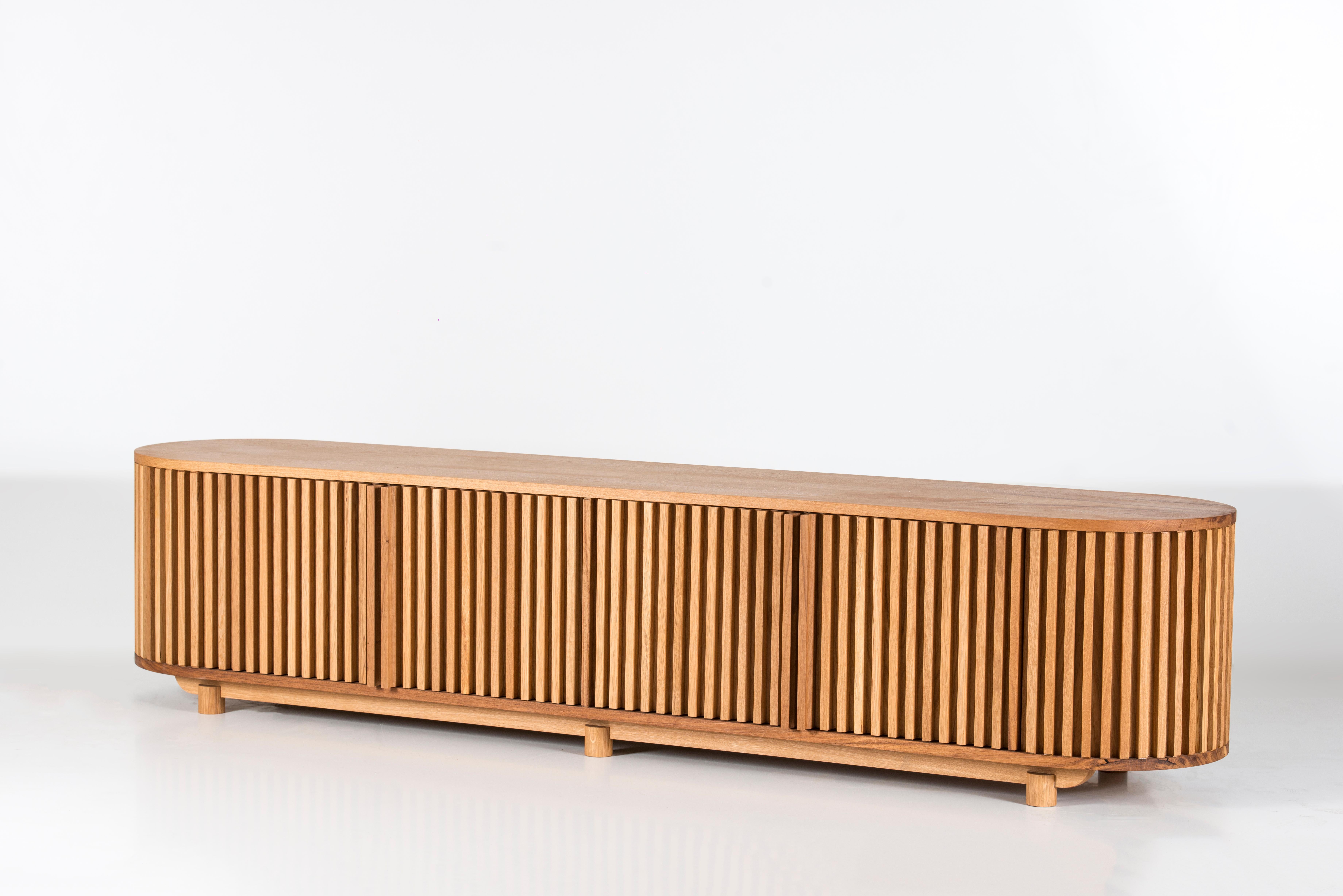 The DOCIA Series Solid Oak TV Unit stands out with its natural wood texture and functional elegance, offering both aesthetic warmth and practical use. Crafted entirely from natural oak wood, every detail of this unit adds a cozy and inviting feel to