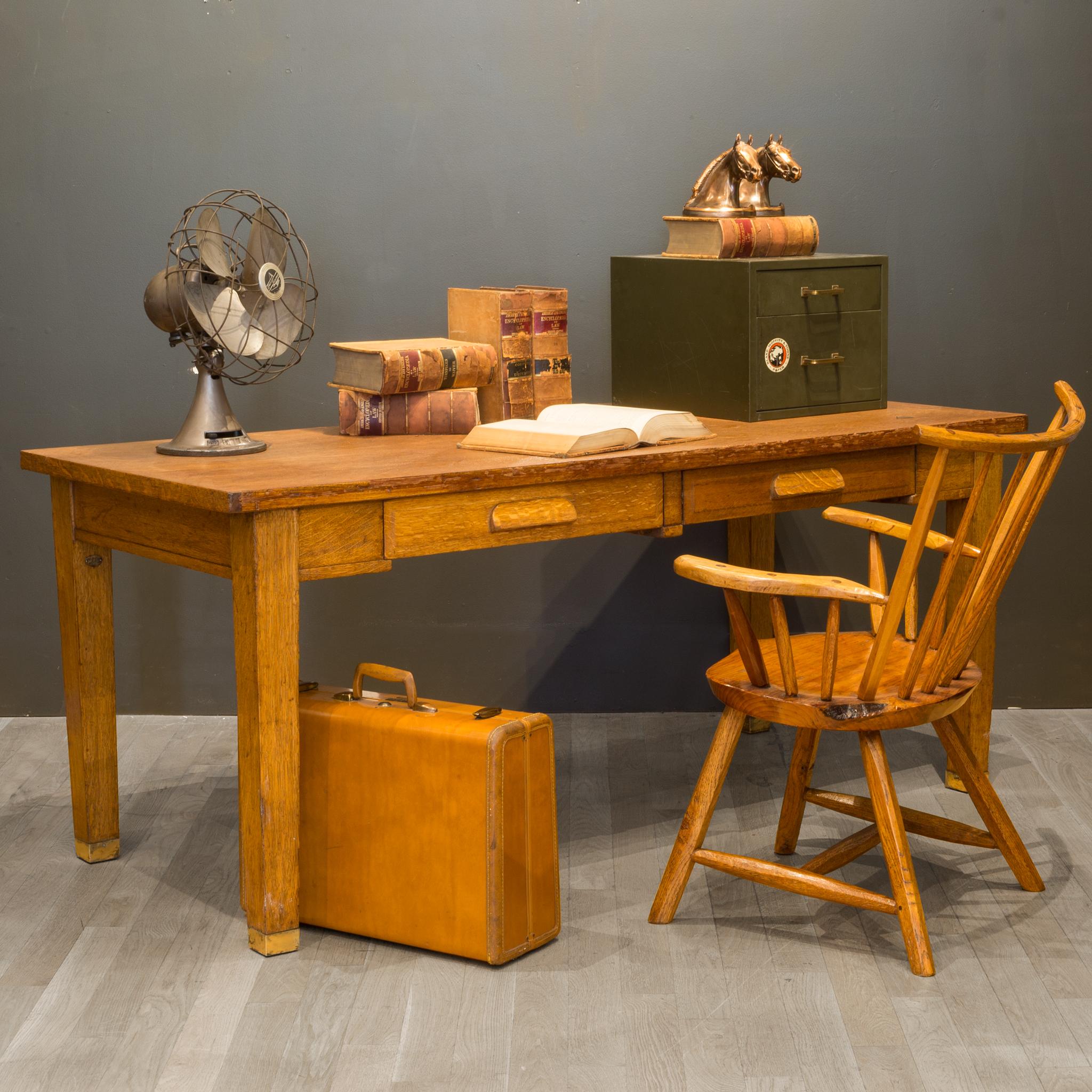 ABOUT

A large solid Oak desk with two drawers and brass feet. Original label in one drawer and a brass tag 