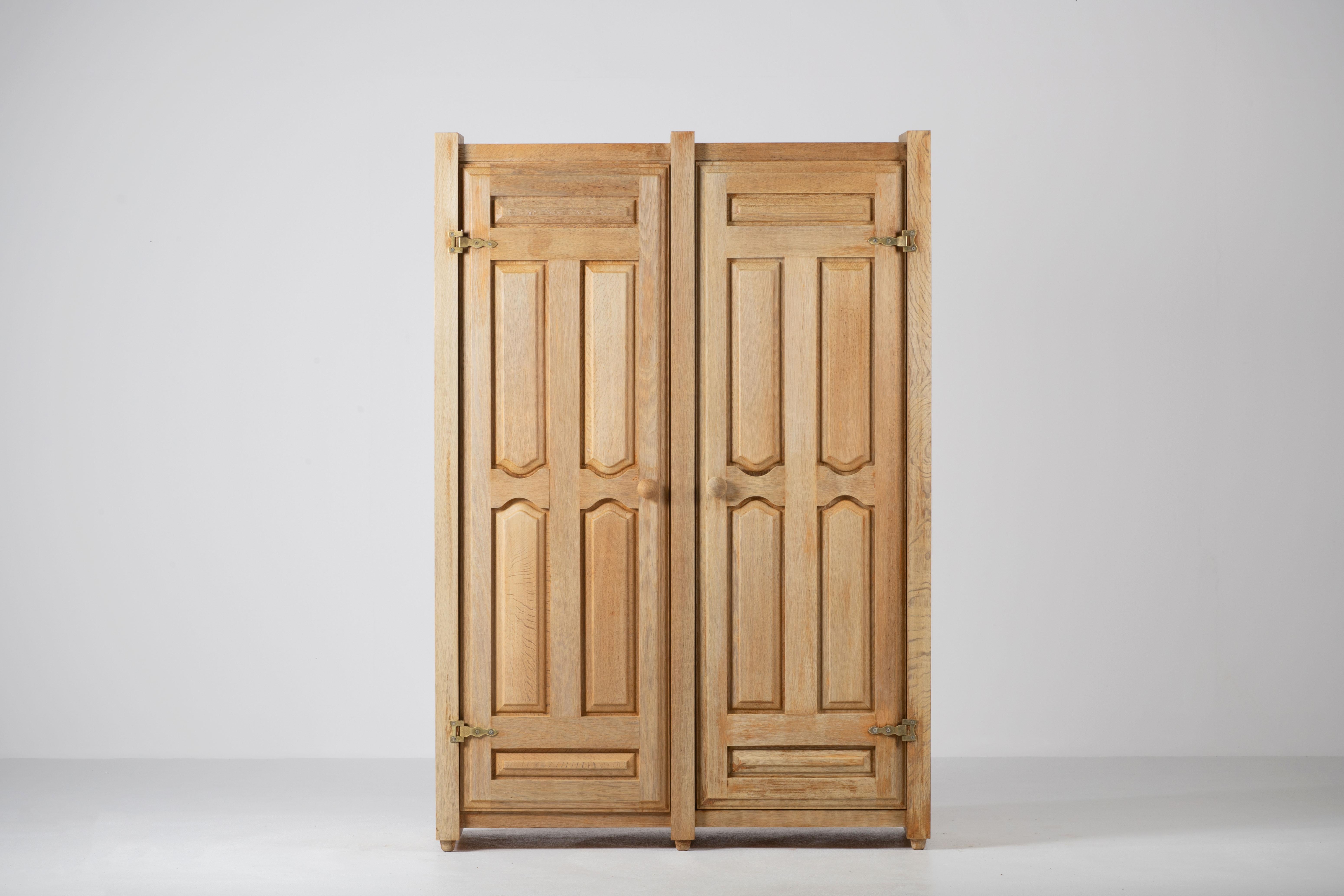 Elegant and rare wardrobe by French designers Guillerme and Chambron featuring two storages compartments, with rack and shelves.

The iconic wardrobe is in overall good vintage condition.


